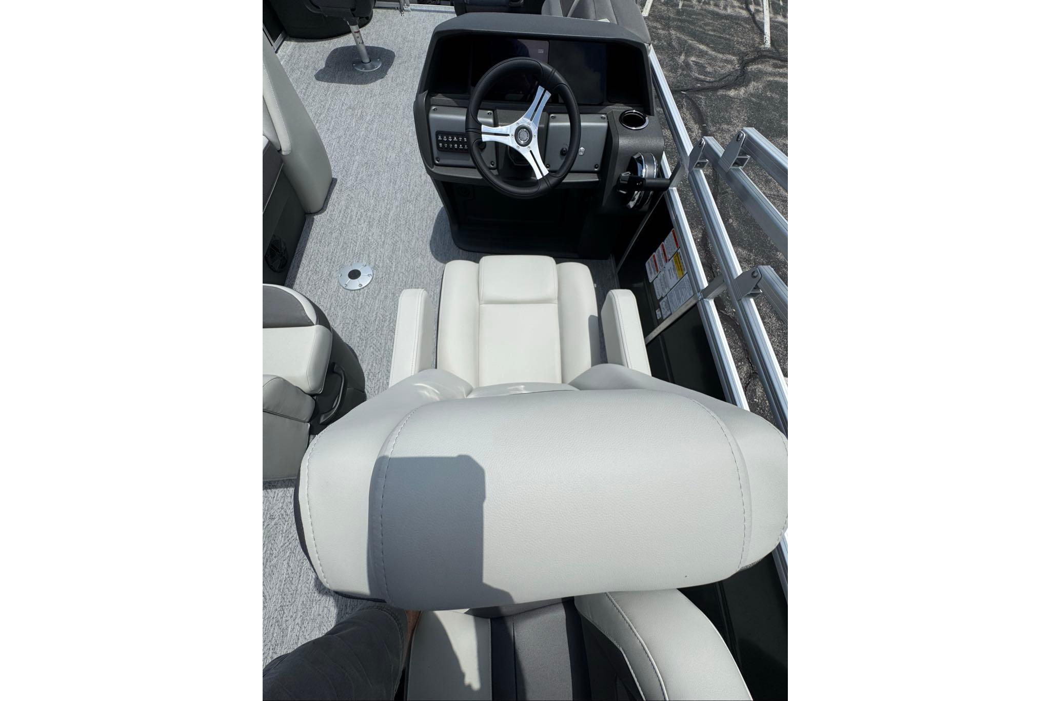 2026 Sun Tracker Fishin' Barge 20 DLX interior with steering console and seating.