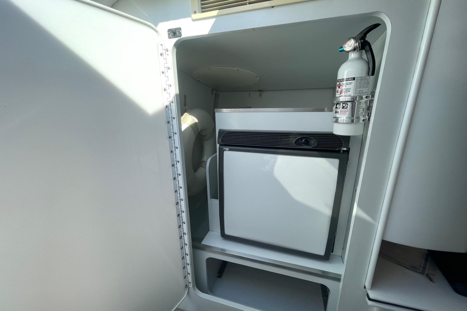 2004 Formula 382 FASTech interior with mini fridge and fire extinguisher.
