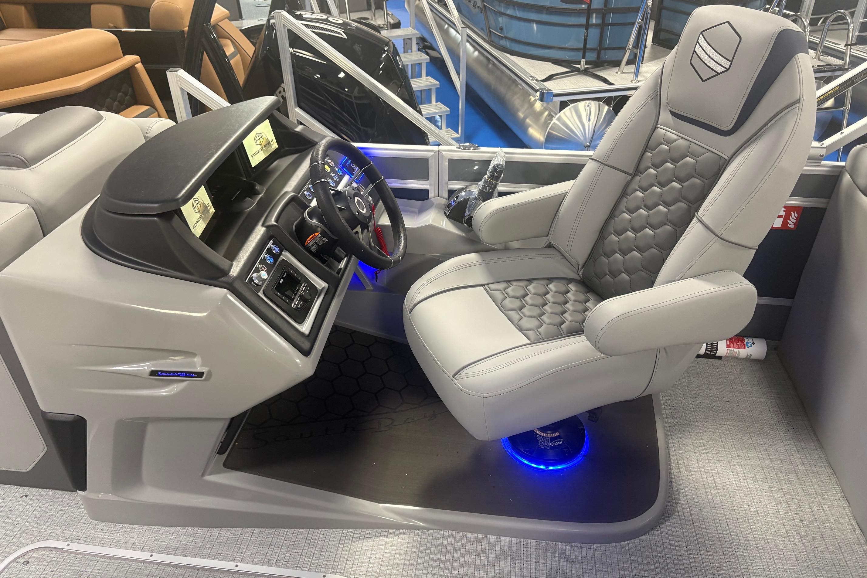 Luxurious 2026 South Bay 523RS boat interior with modern captain's chair and sleek dashboard design.