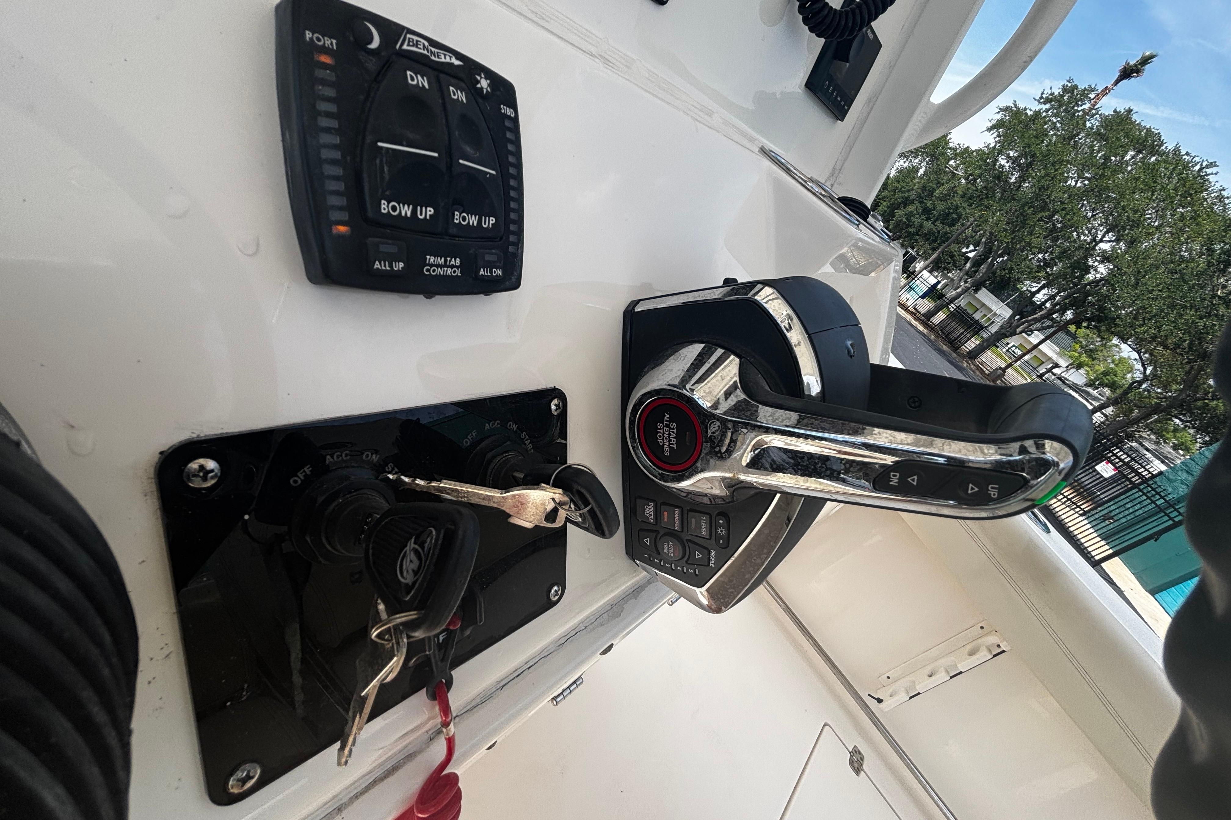 2023 Cobia 262 Center Console boat controls with trim tab and throttle lever.