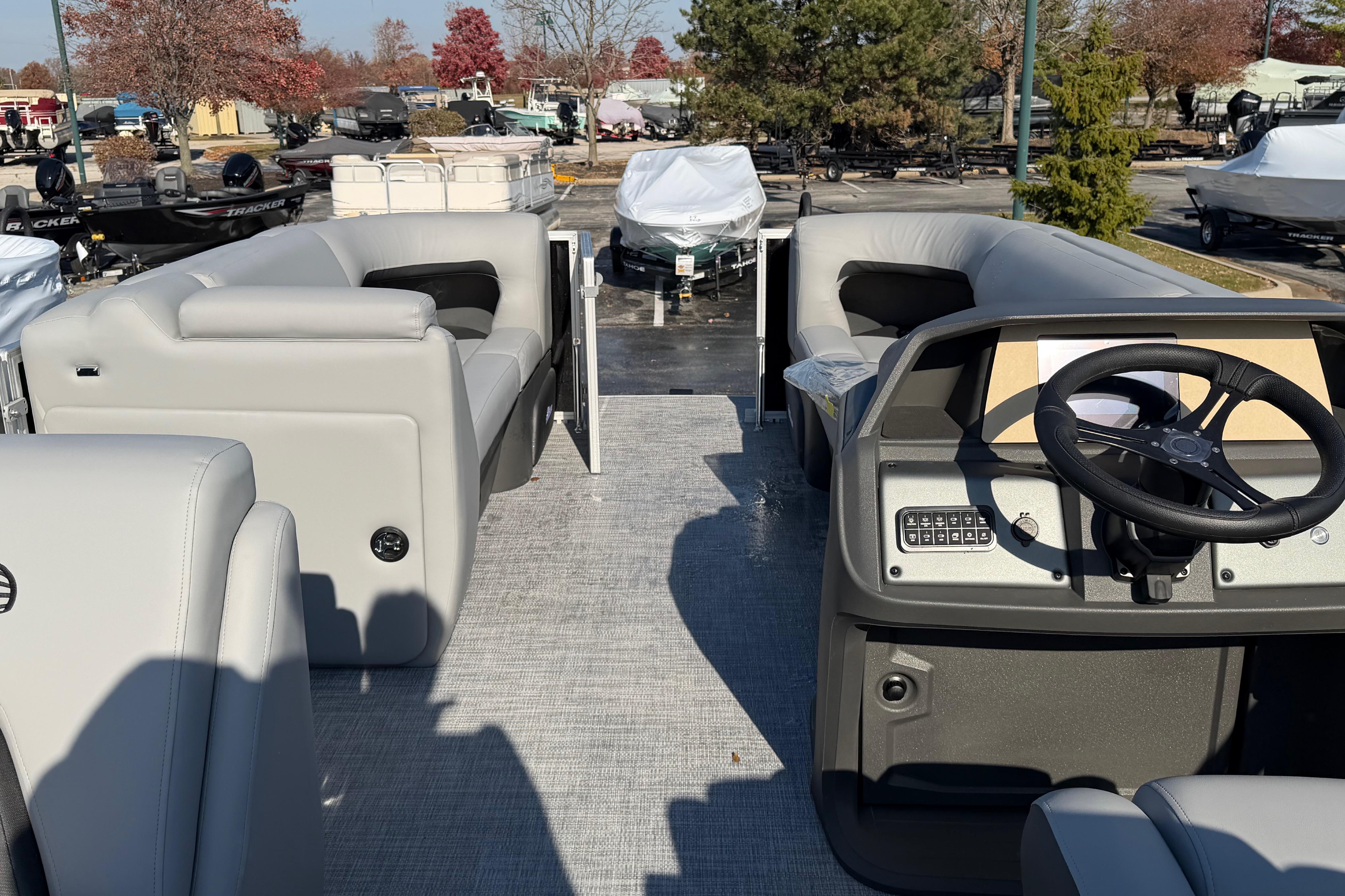 2026 Sun Tracker Party Barge 20 DLX interior with plush seating and modern helm.