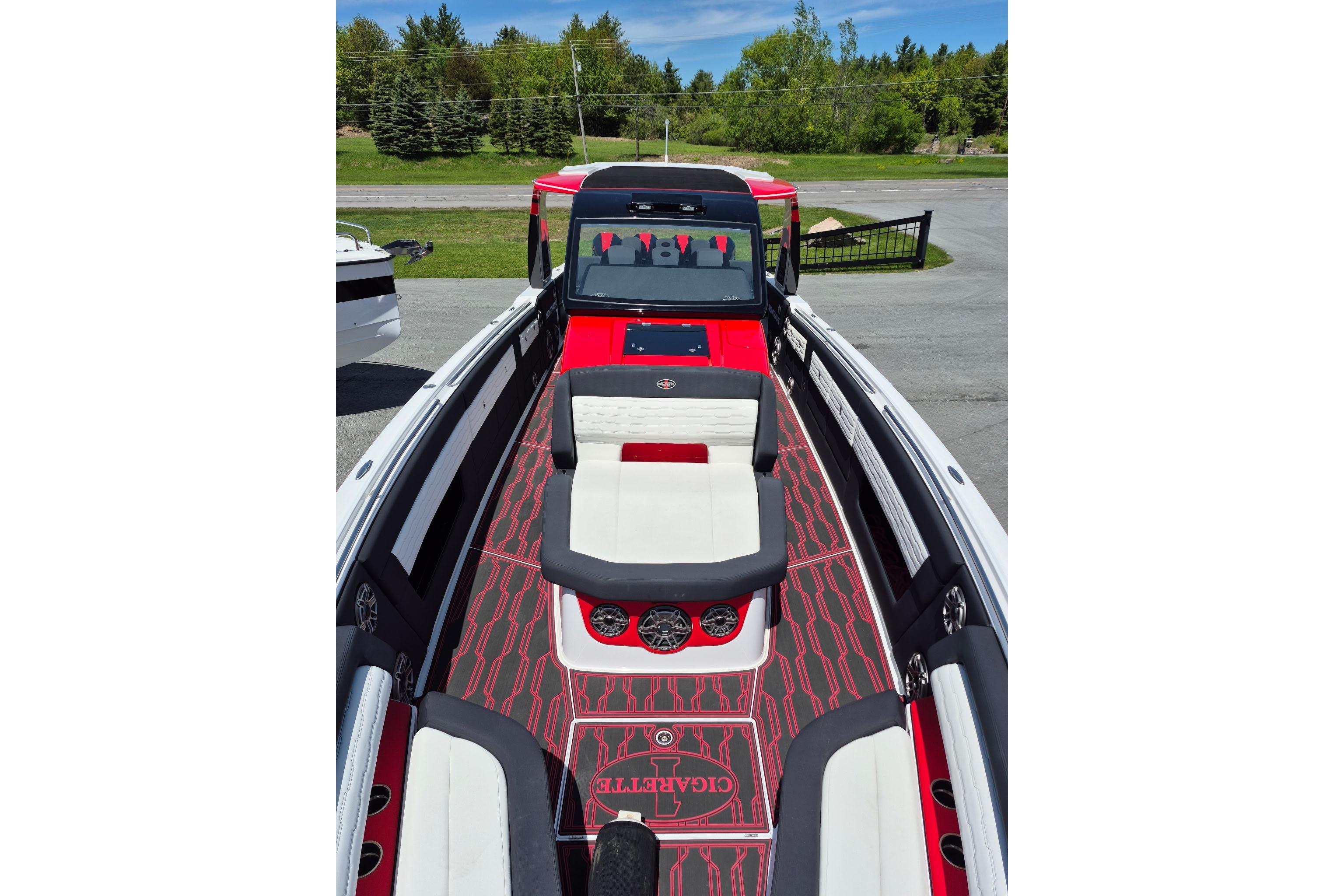 2021 Cigarette 41' Nighthawk boat with red and white interior, docked outdoors.