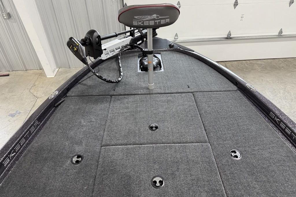 2025 Skeeter ZX150 boat interior with carpeted deck and mounted trolling motor.