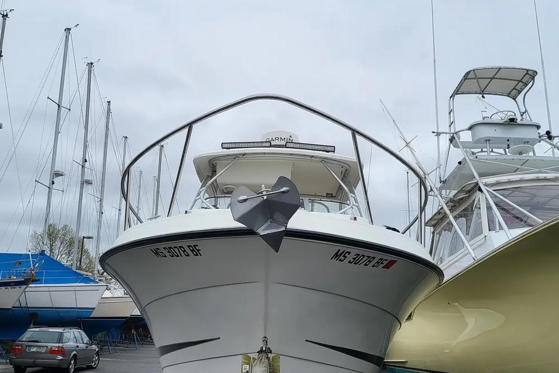 2003 Hydra-Sports Vector 2800 WA boat docked, front view with anchor and marina background.