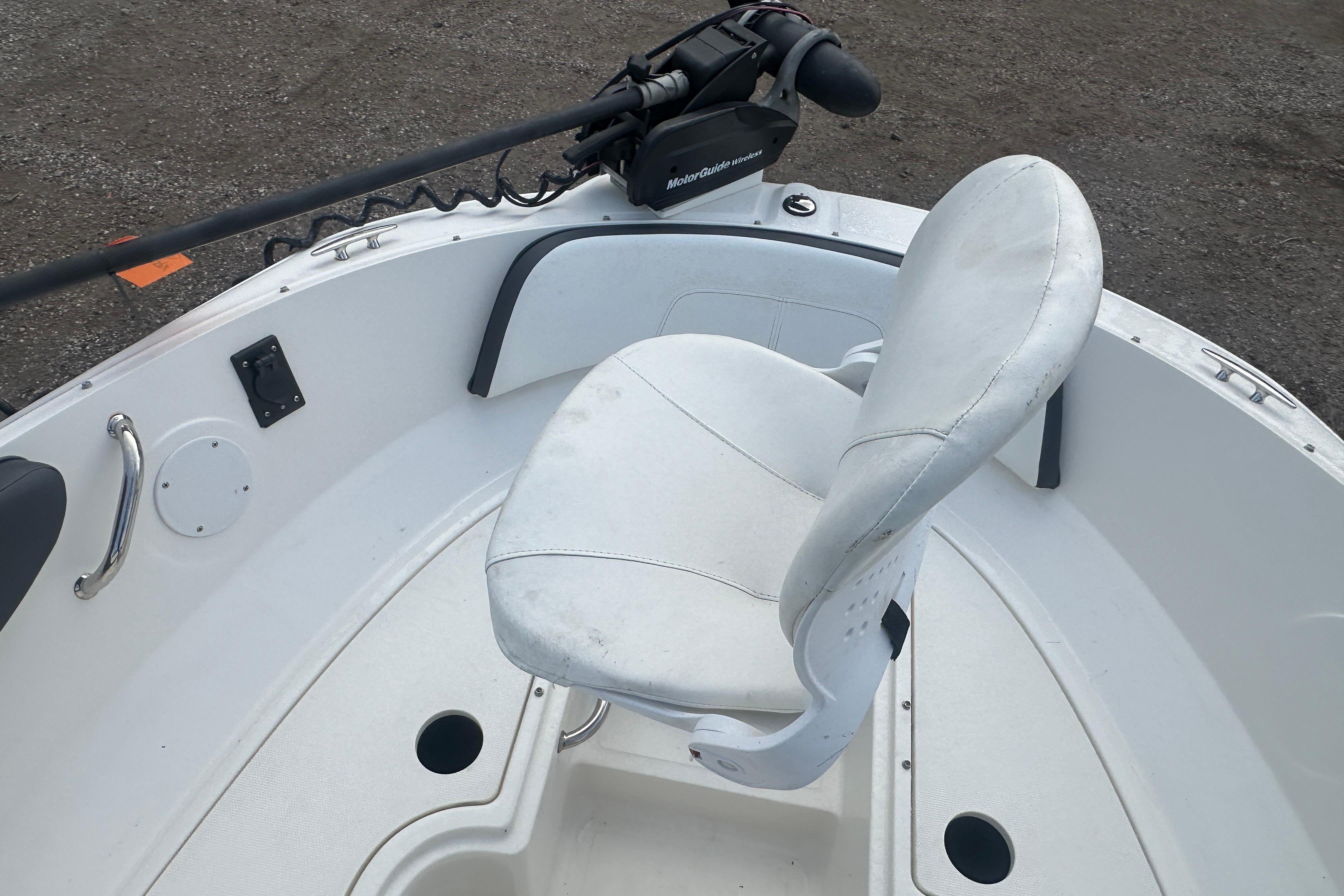 2017 Sea Ray SPX 190 Outboard boat interior with white seating and trolling motor.