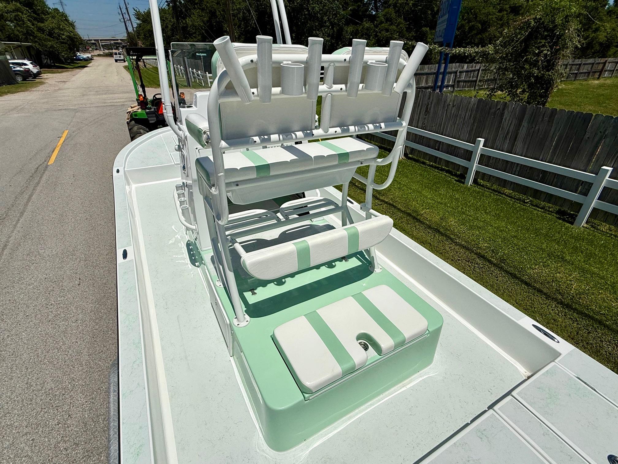 2023 Shallow Sport 24 Sport boat with green and white seating on a sunny day.