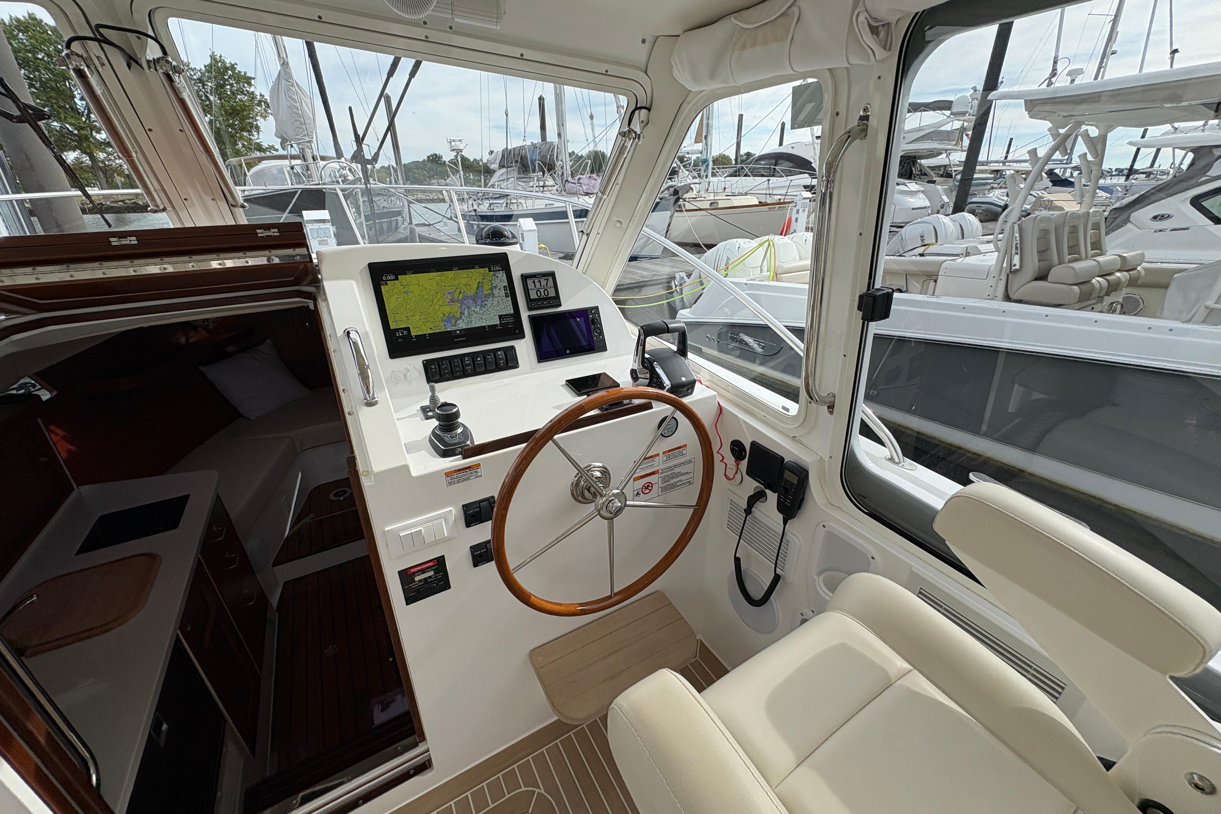 Interior of 2023 MJM 35 boat with steering wheel and navigation system.