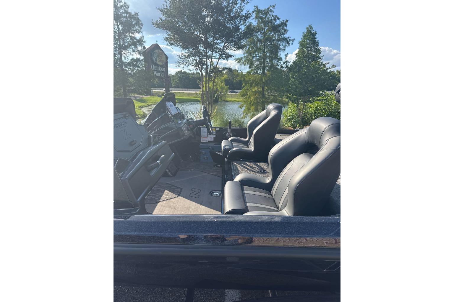 2026 Nitro Z21 XL boat interior with sleek black seats, parked near Outdoor World.