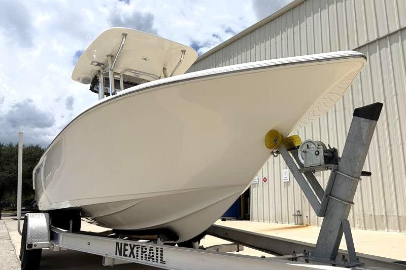 2023 Key West 203 FS boat on trailer, parked outside a metal building.