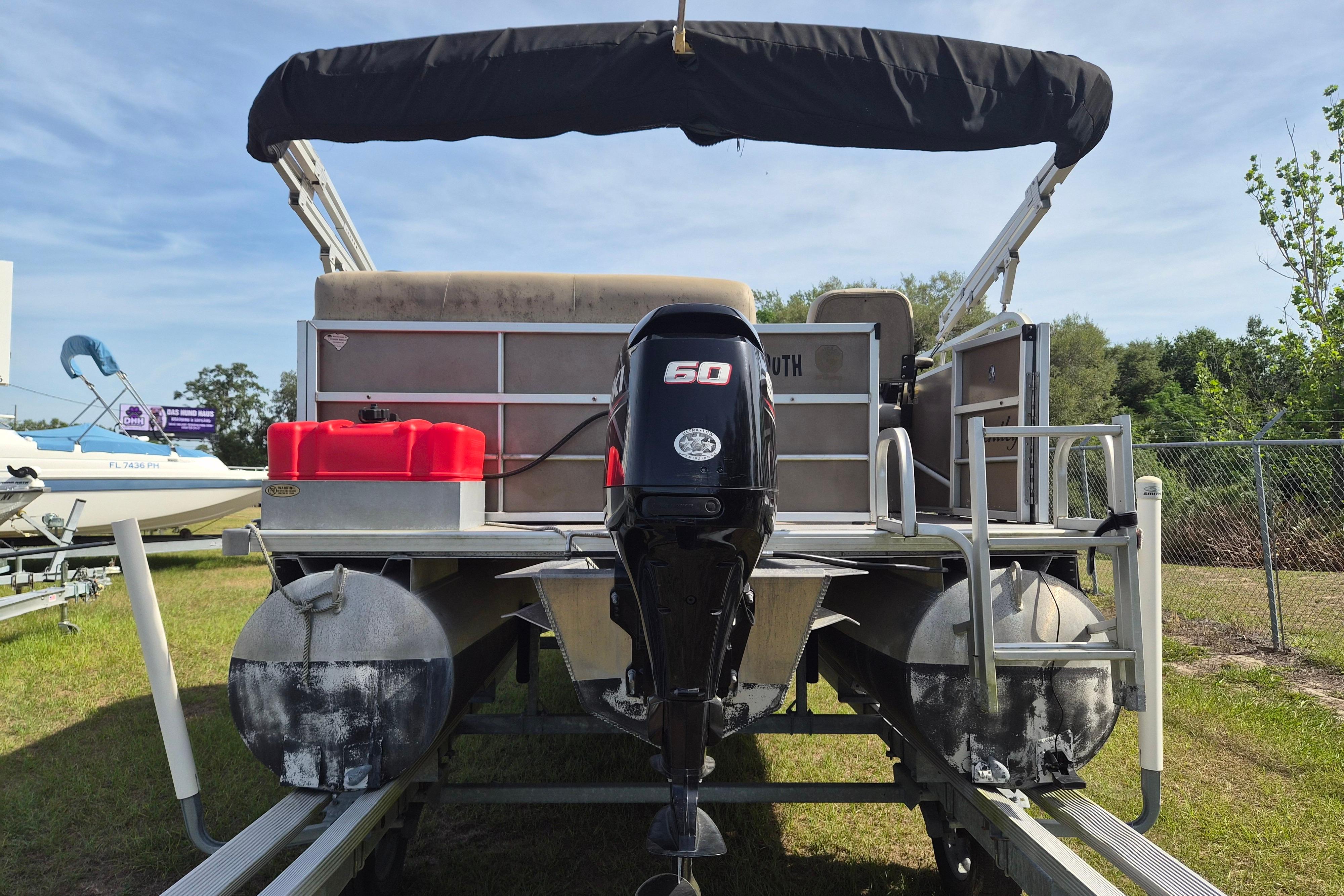 2004 Bentley Pontoons 180 CRUISE with 60 HP outboard motor, parked on grass.