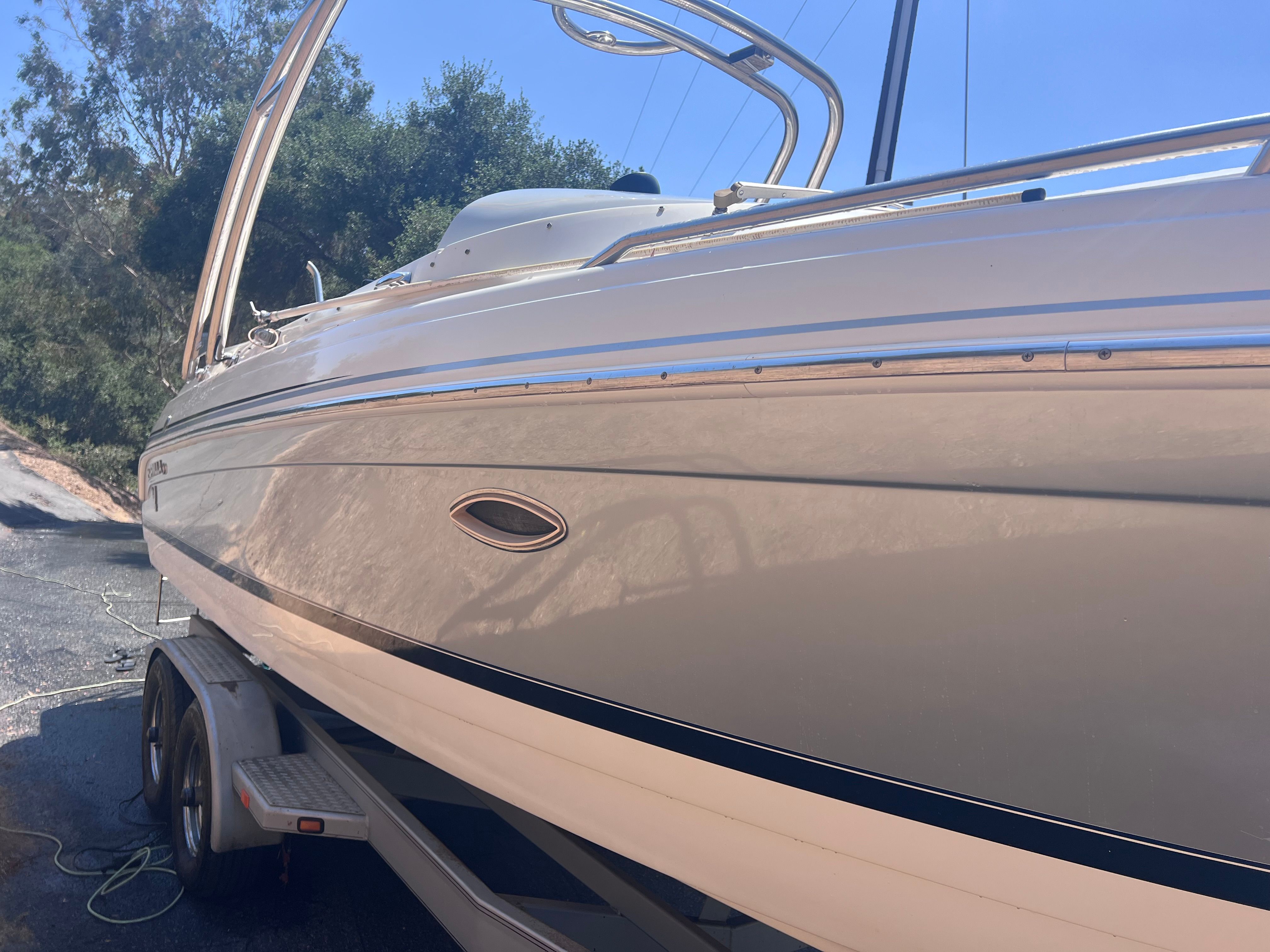 2006 Formula 260 Sun Sport boat on trailer, side view.