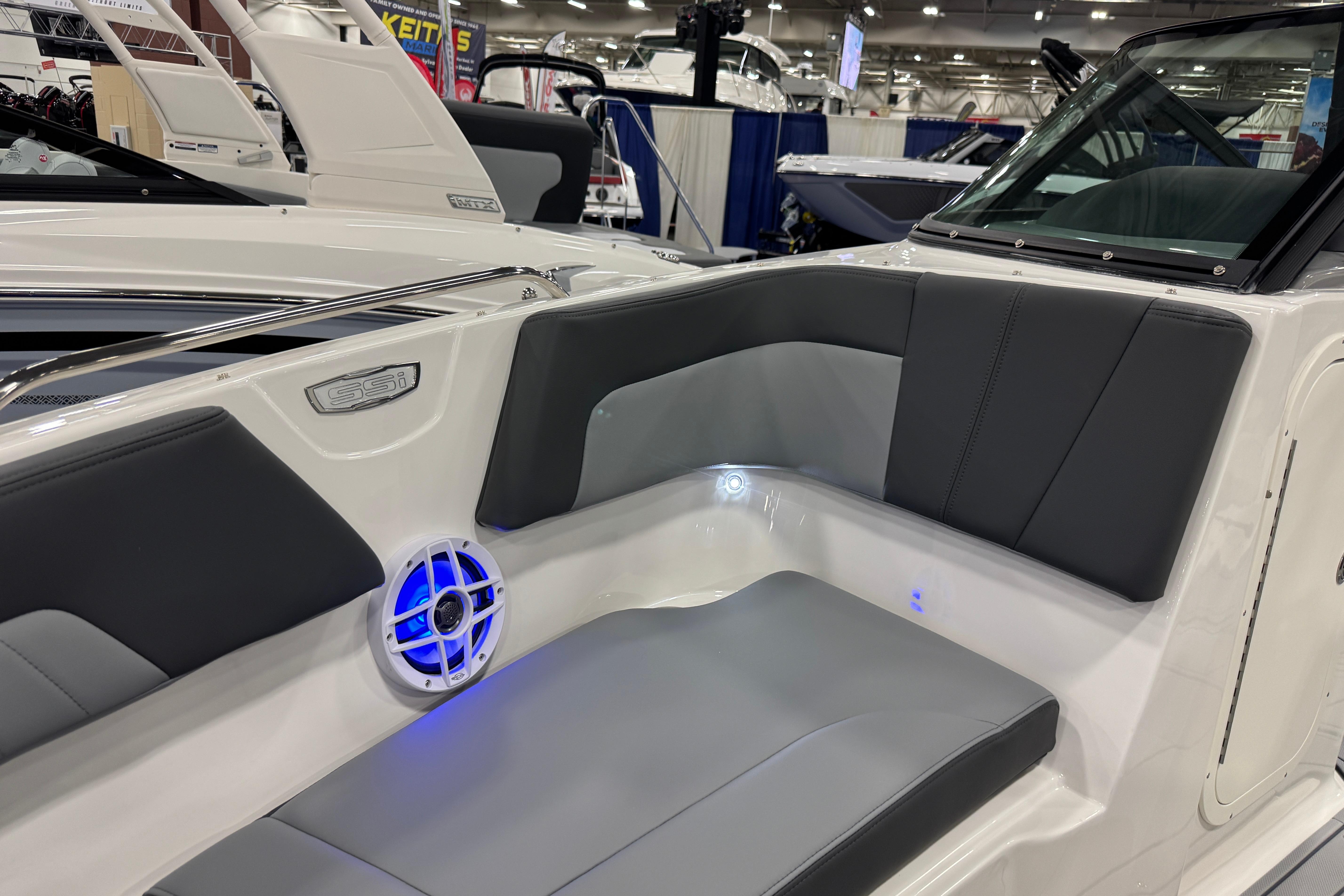 2026 Chaparral 23 SSi boat interior with gray seating and blue LED lighting.