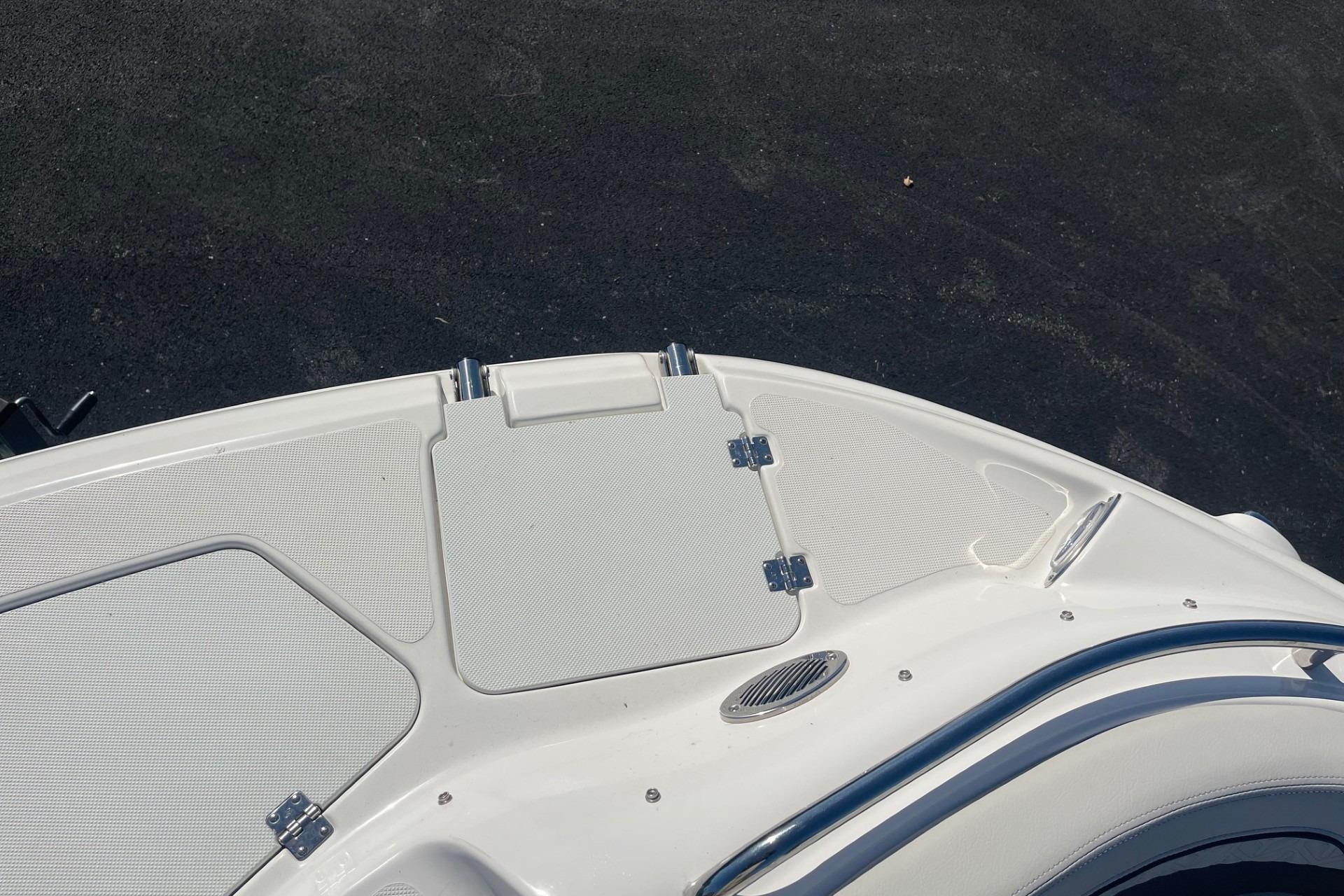 2023 Hurricane SunDeck 2400 OB boat deck with sleek white finish and stainless steel accents.