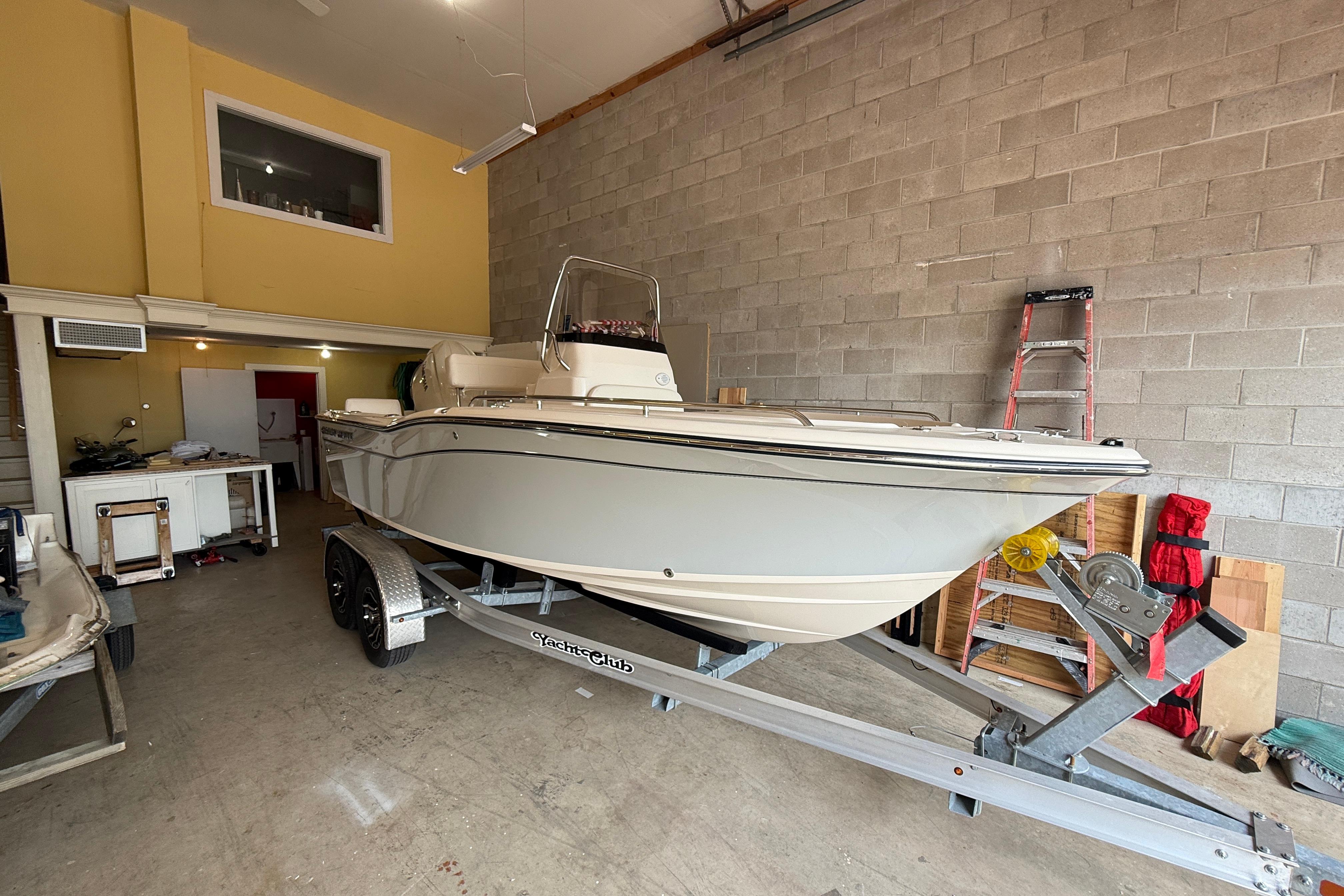 2025 Grady-White Fisherman 180 boat on trailer in a garage setting.