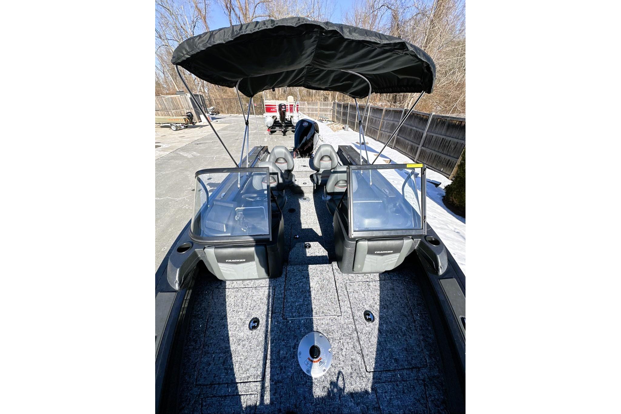 2026 Tracker Targa V-19 WT boat with canopy, parked outdoors on a sunny day.