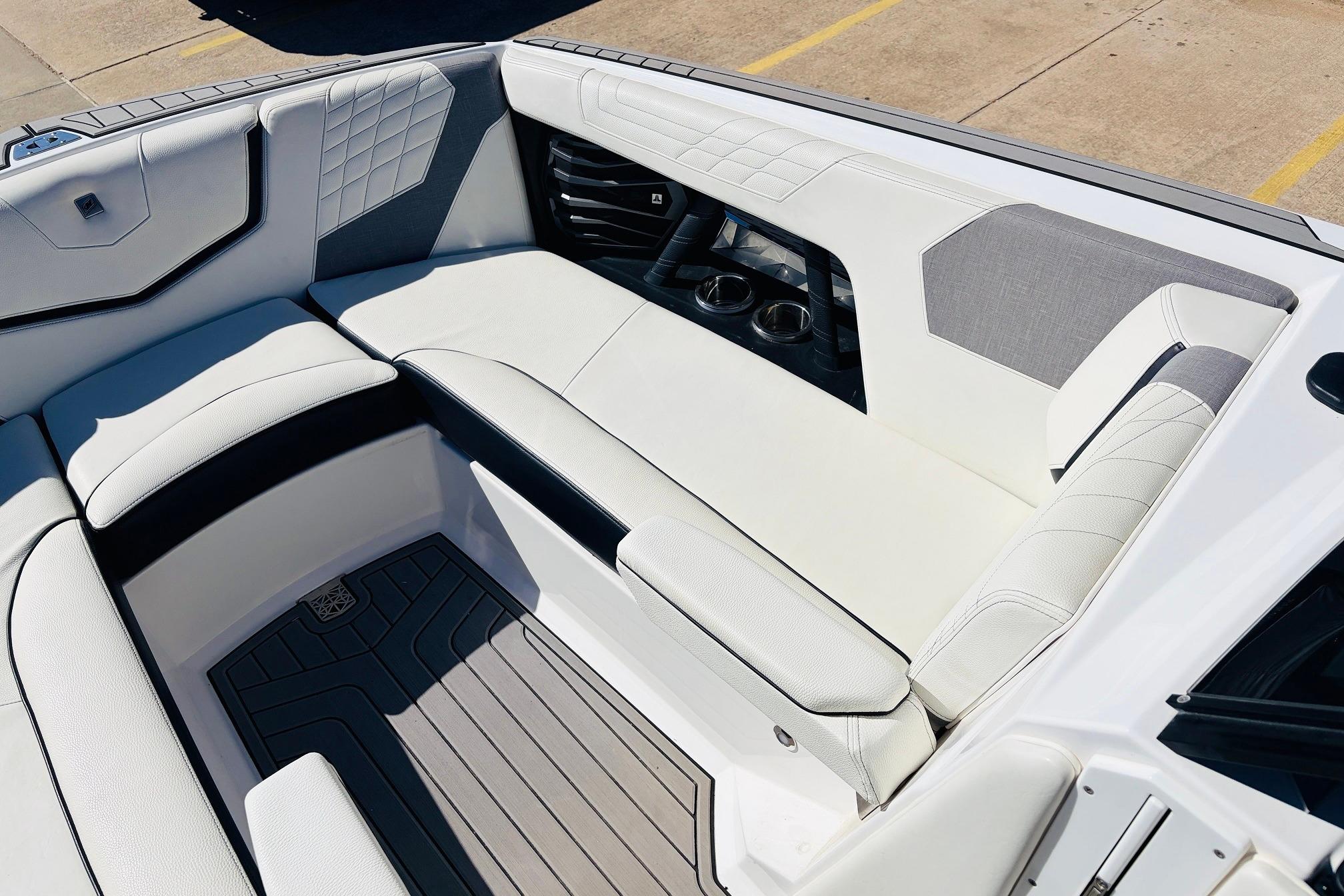 2023 Nautique Super Air Nautique G25 interior with luxurious white seating and cup holders.
