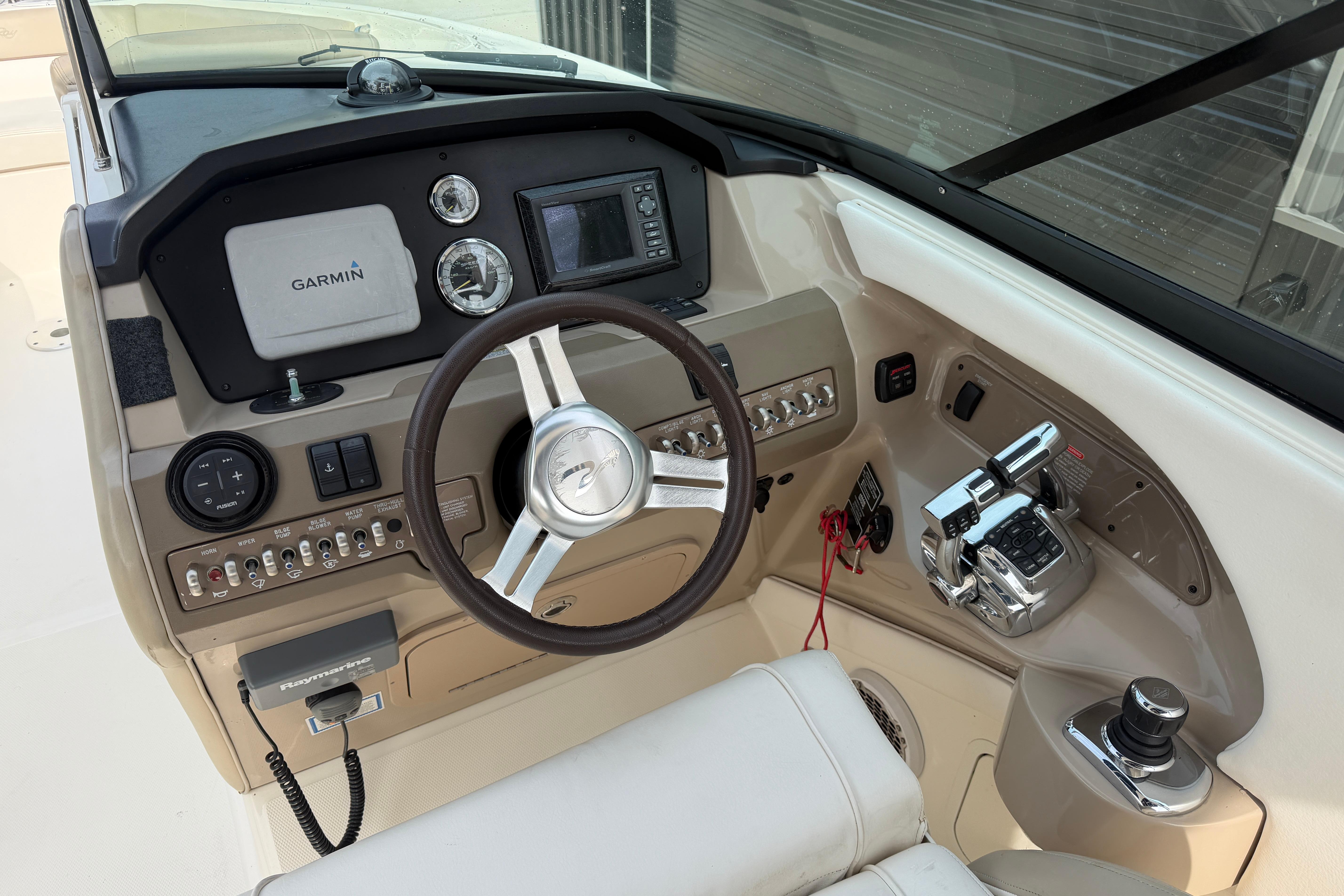 Cockpit of 2013 Sea Ray 300 SLX boat with Garmin navigation system and controls.