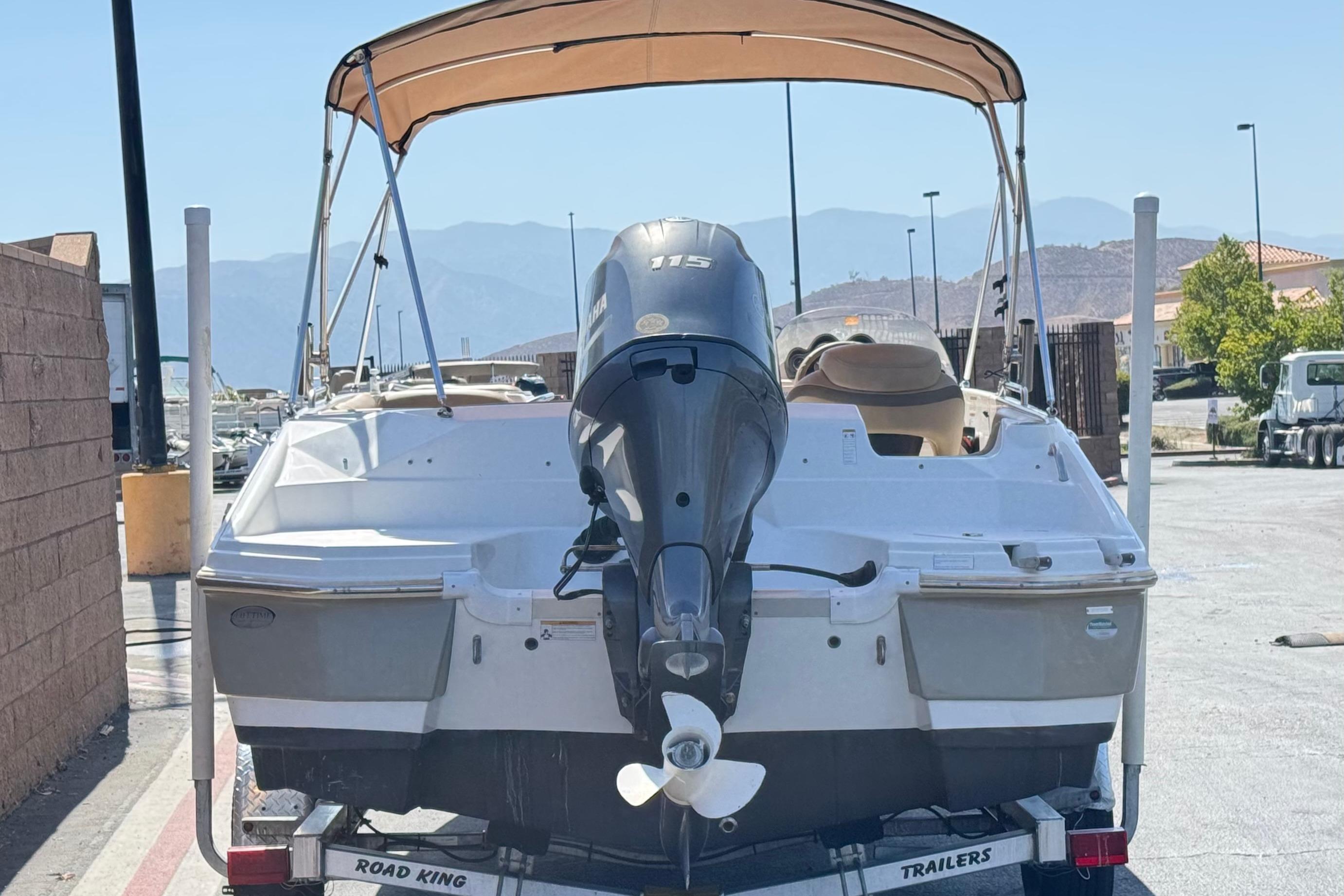 2020 NauticStar 203 SC boat on trailer with canopy and outboard motor.