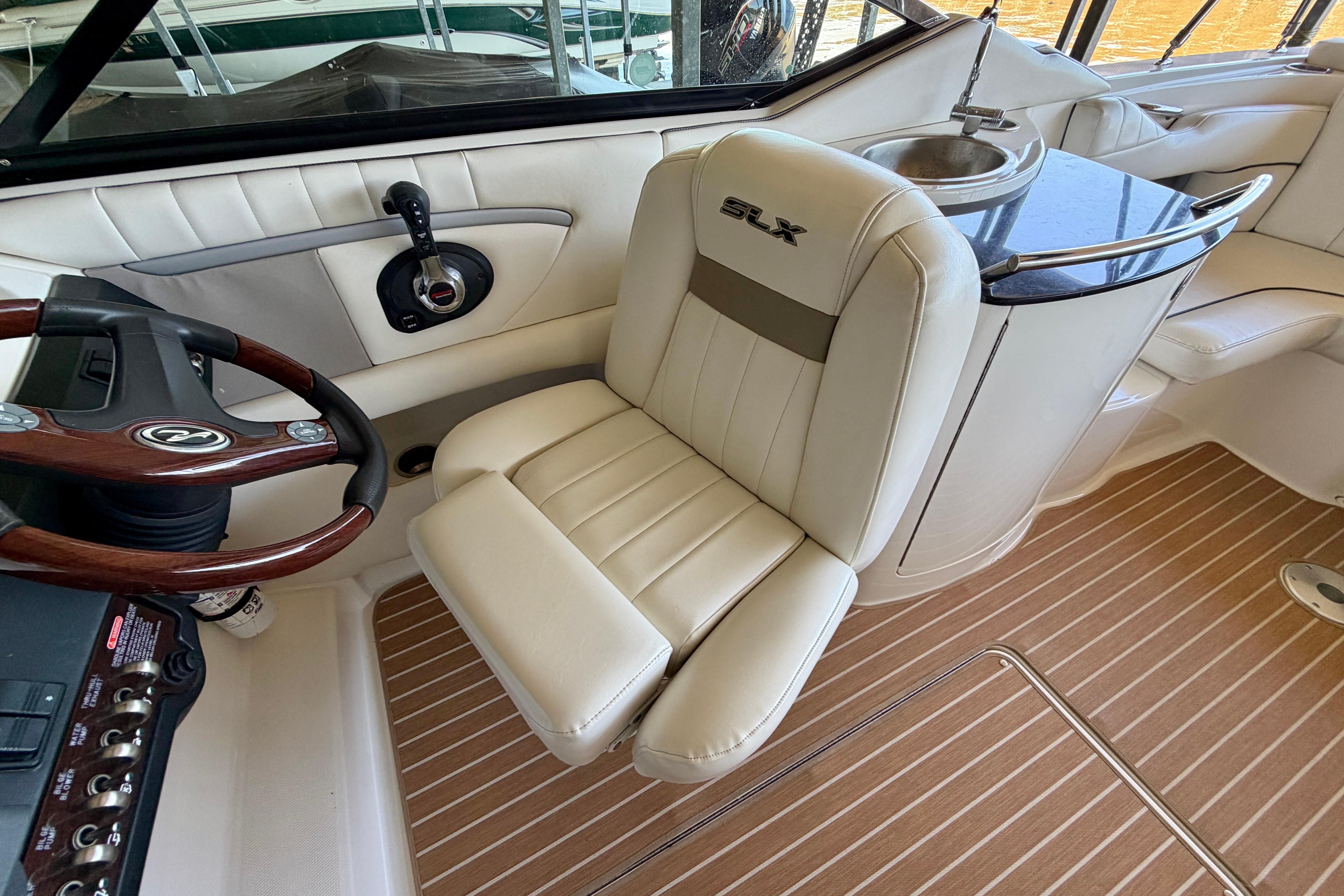 Interior of 2007 Sea Ray 270 SLX boat with steering wheel and seating.