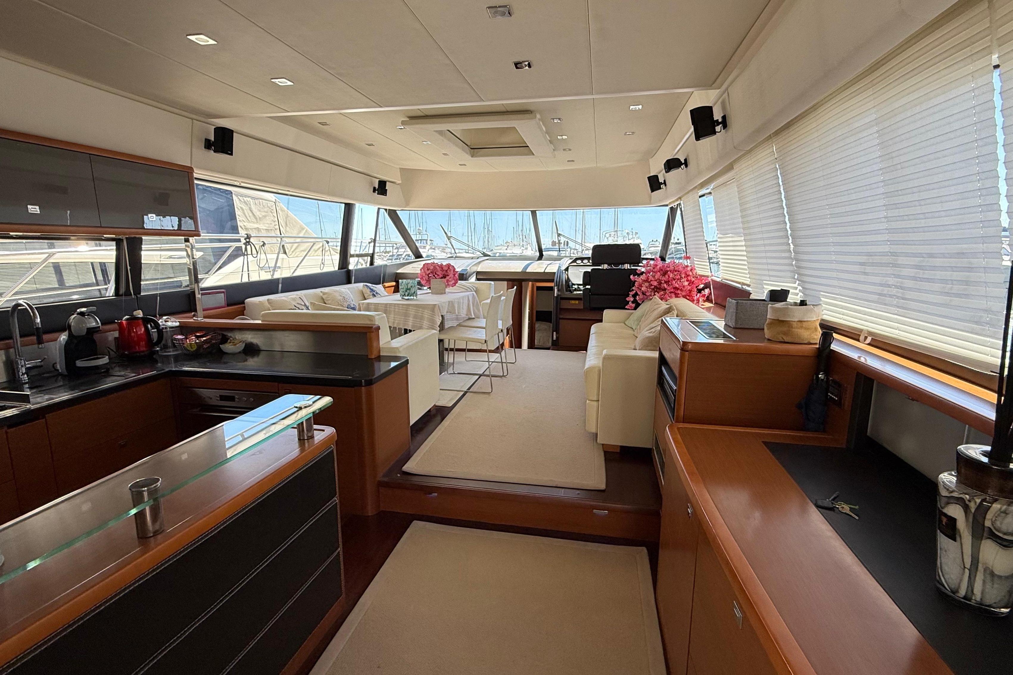 Luxurious interior of a 2013 Prestige 620 yacht with modern kitchen and seating area.