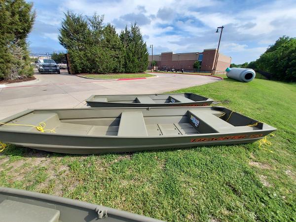 2025 Tracker Grizzly 1236 Utility boats on grass, sunny day.