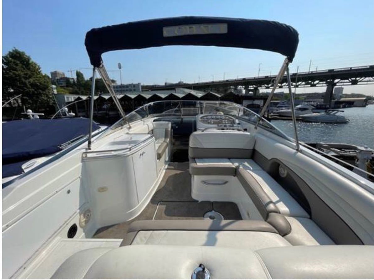 Interior view of a 1999 Cobalt 293 boat by the water.