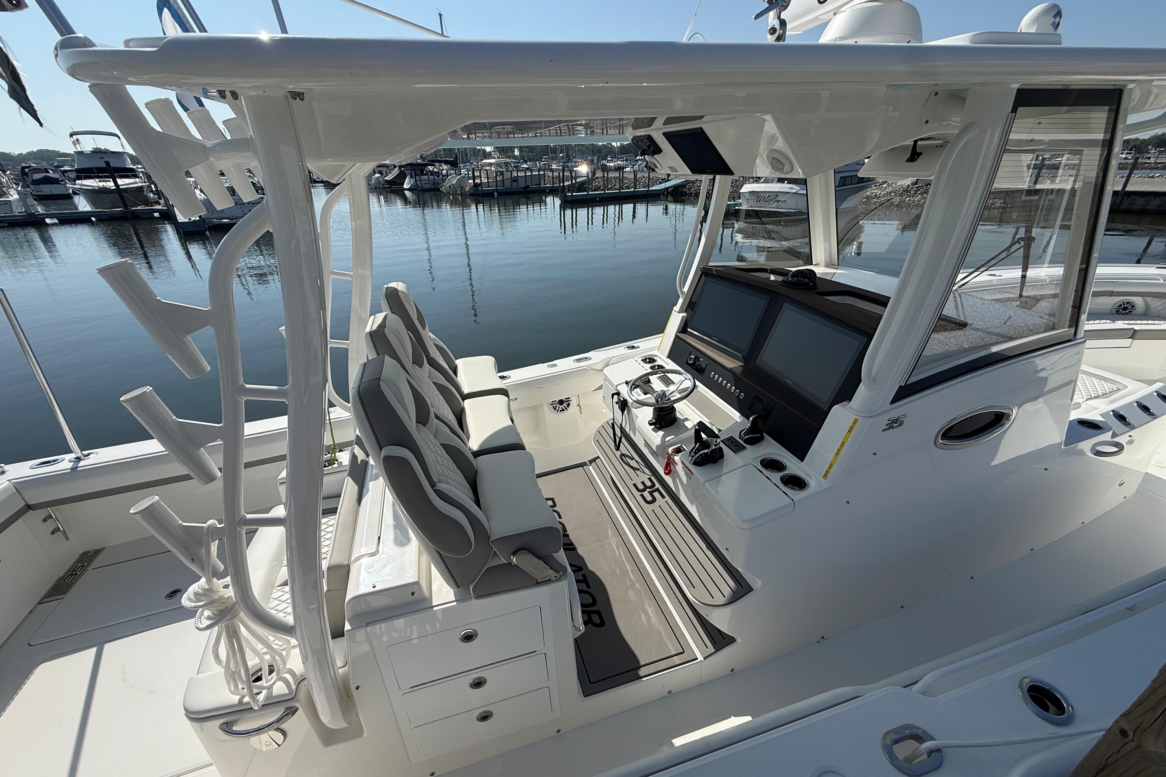 2026 Regulator 35 boat interior with helm, seating, and rod holders at marina.