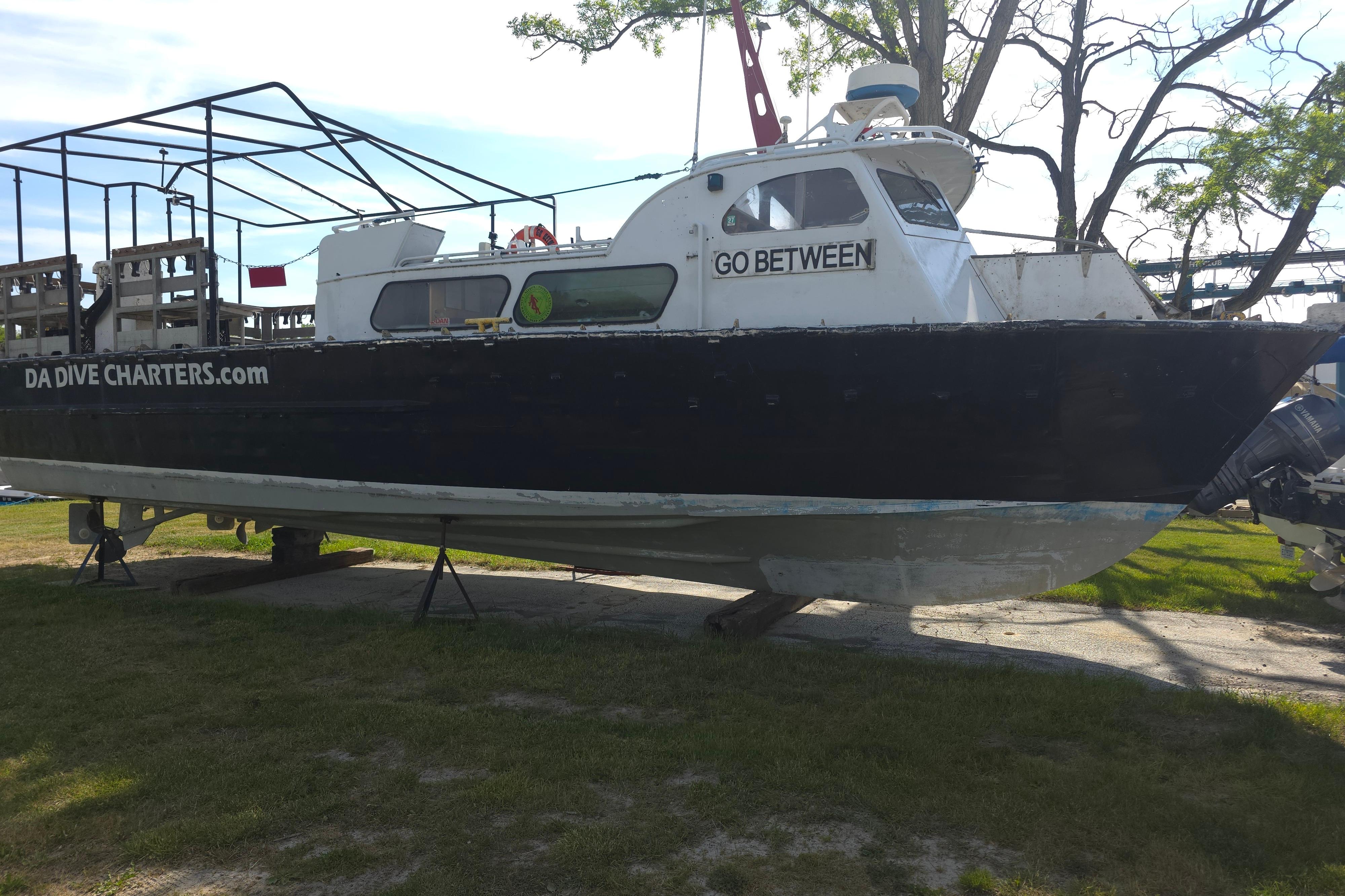 1974 Breaux's Bay Craft passenger boat "Go Between" on land, used for dive charters.