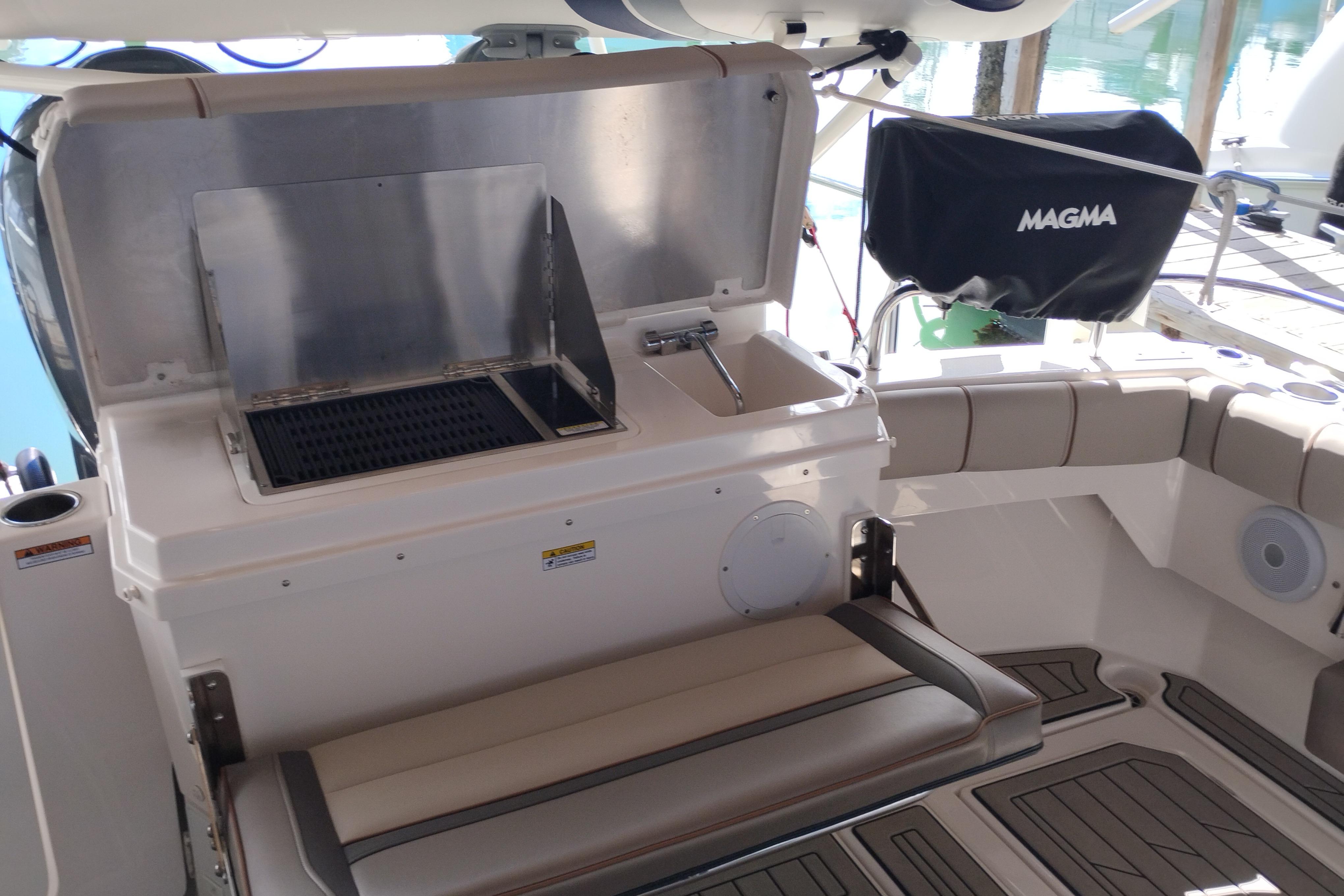2022 Cutwater C-32 Coupe boat interior with grill and seating area.