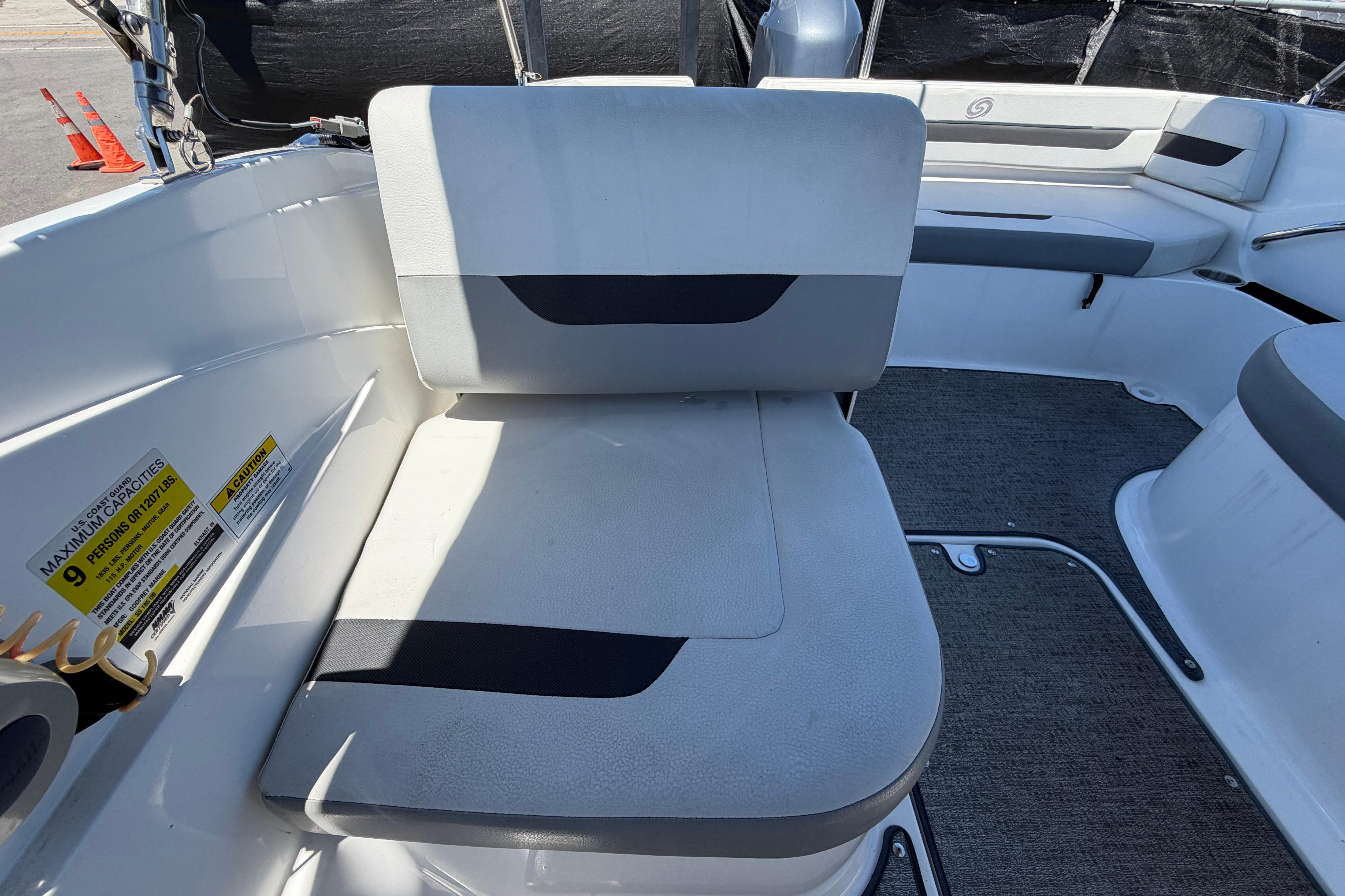 2022 Hurricane SunDeck Sport 185 OB boat interior with seating and capacity label.