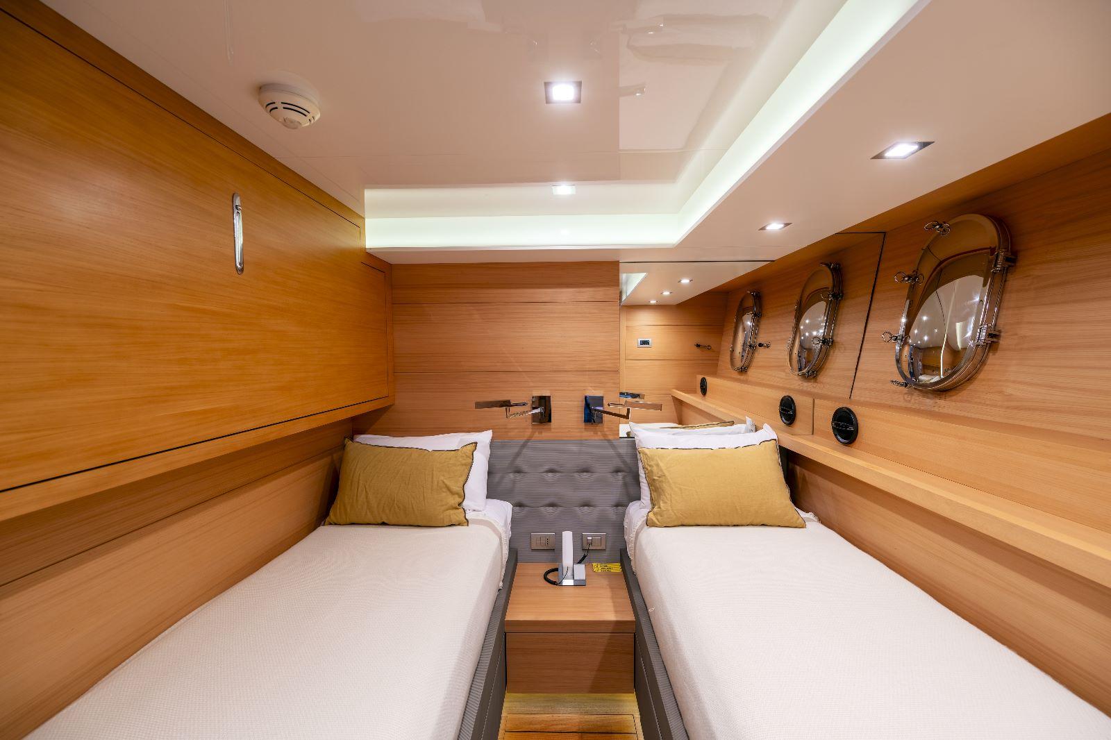 Luxurious Maiora 27 yacht cabin interior with twin beds, wood paneling, and modern lighting, 2011 model.