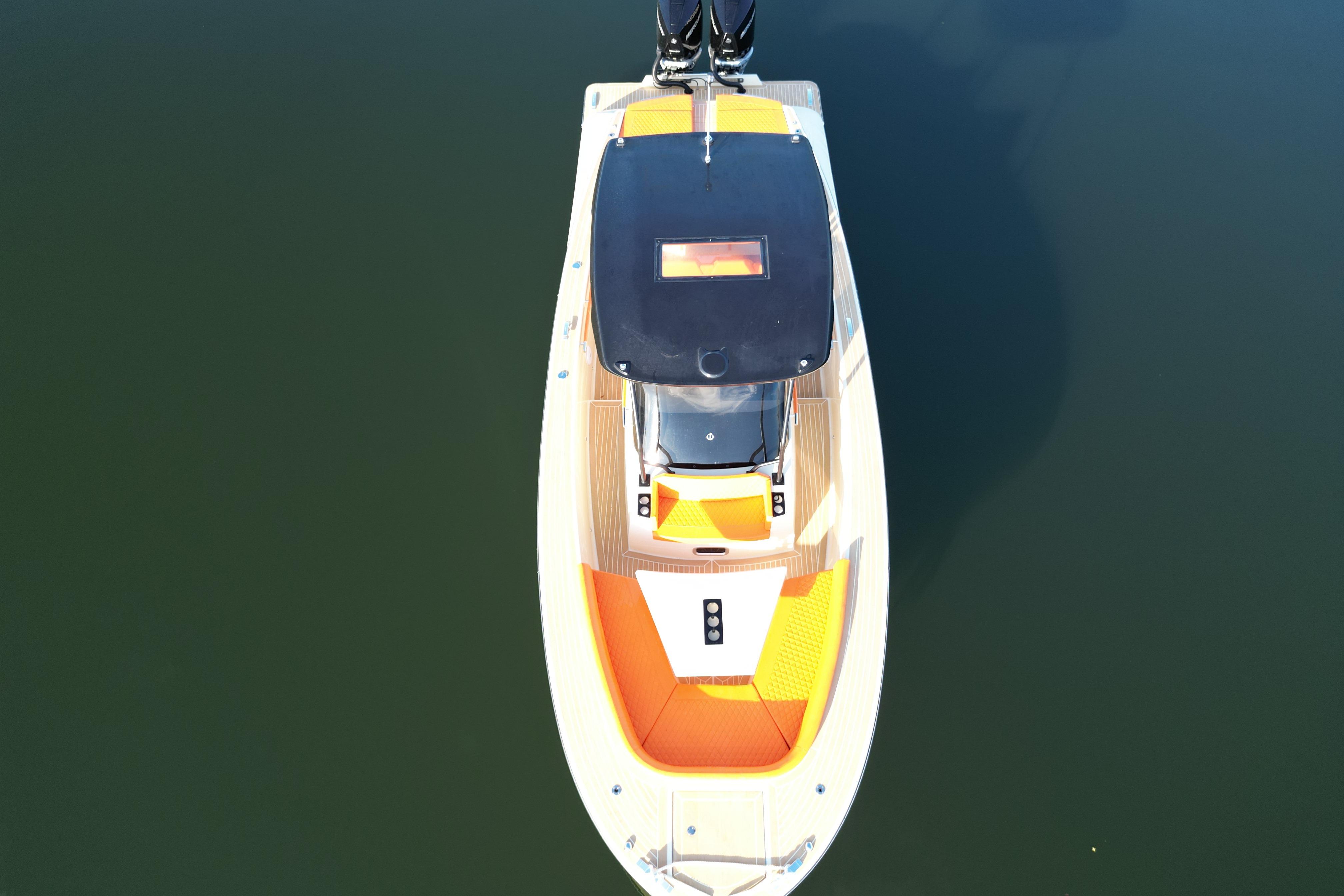 Aerial view of 2026 Lilybaeum Lipari 31 boat with orange seating on calm water.