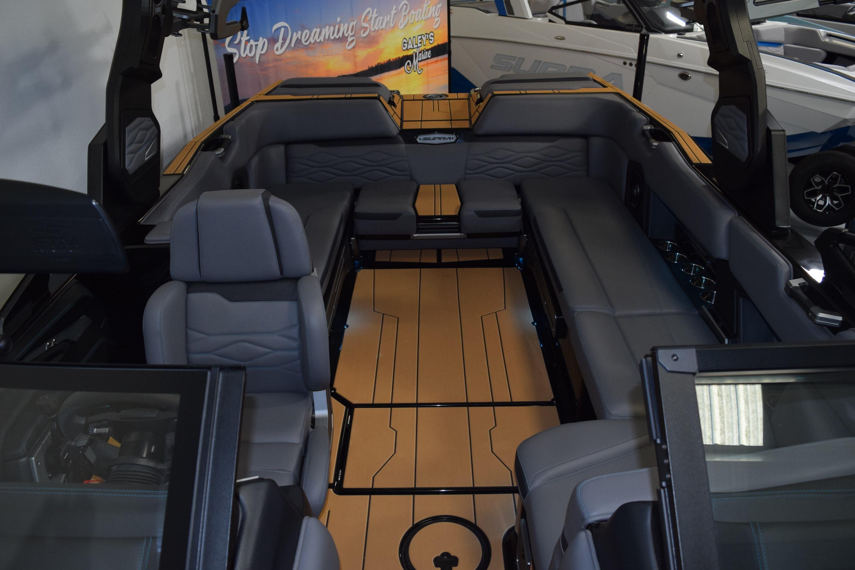 Interior of 2026 Supra SL 550 boat with luxurious seating and sleek design.