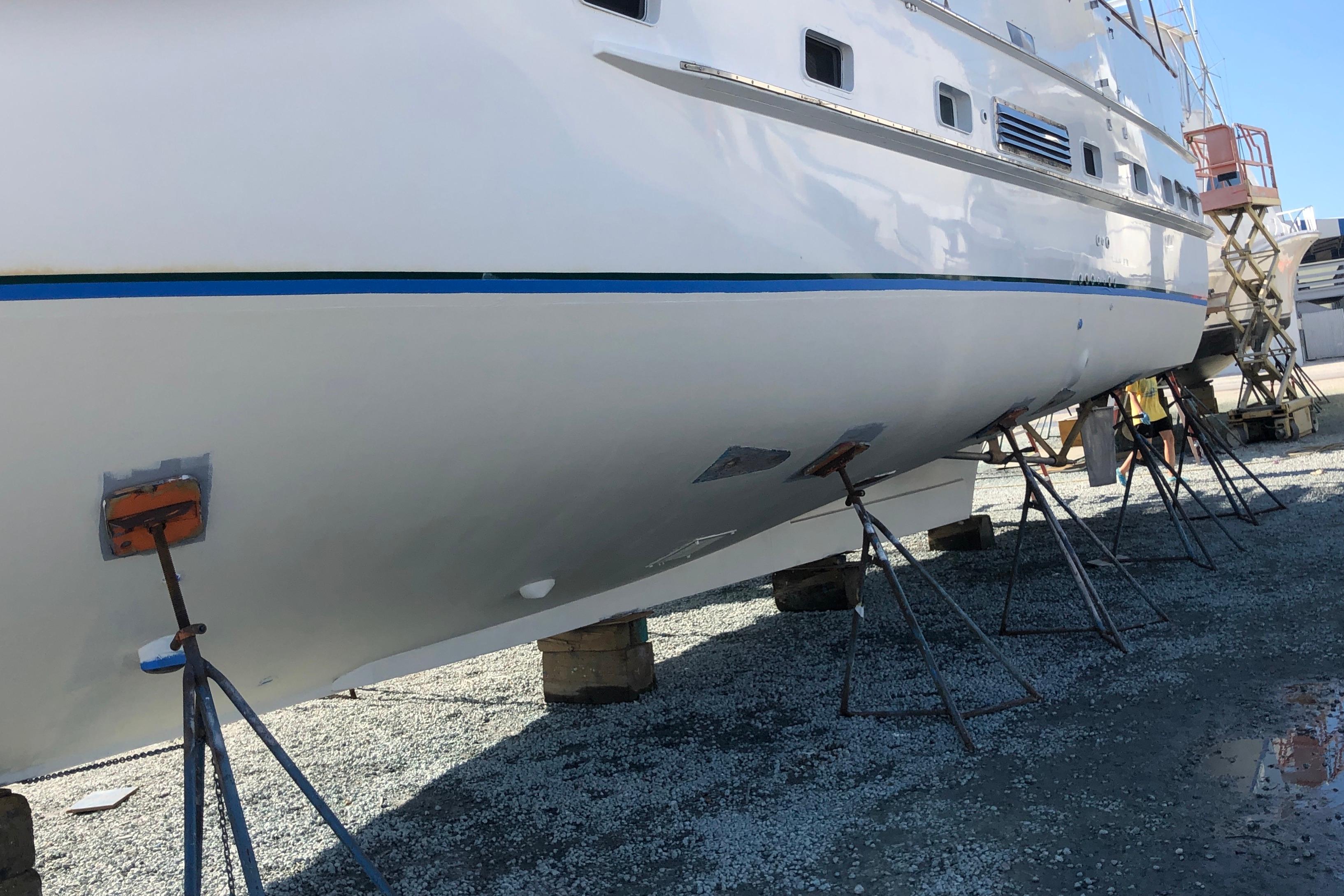 1982 DeFever 52 Offshore Cruiser on stands for maintenance, side view.