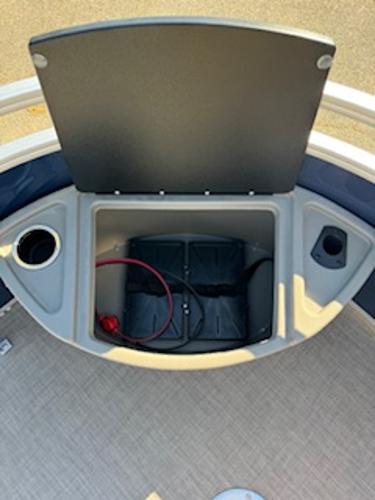 Storage compartment in Sun Tracker Fishin' Barge 22 DLX 2025 boat.