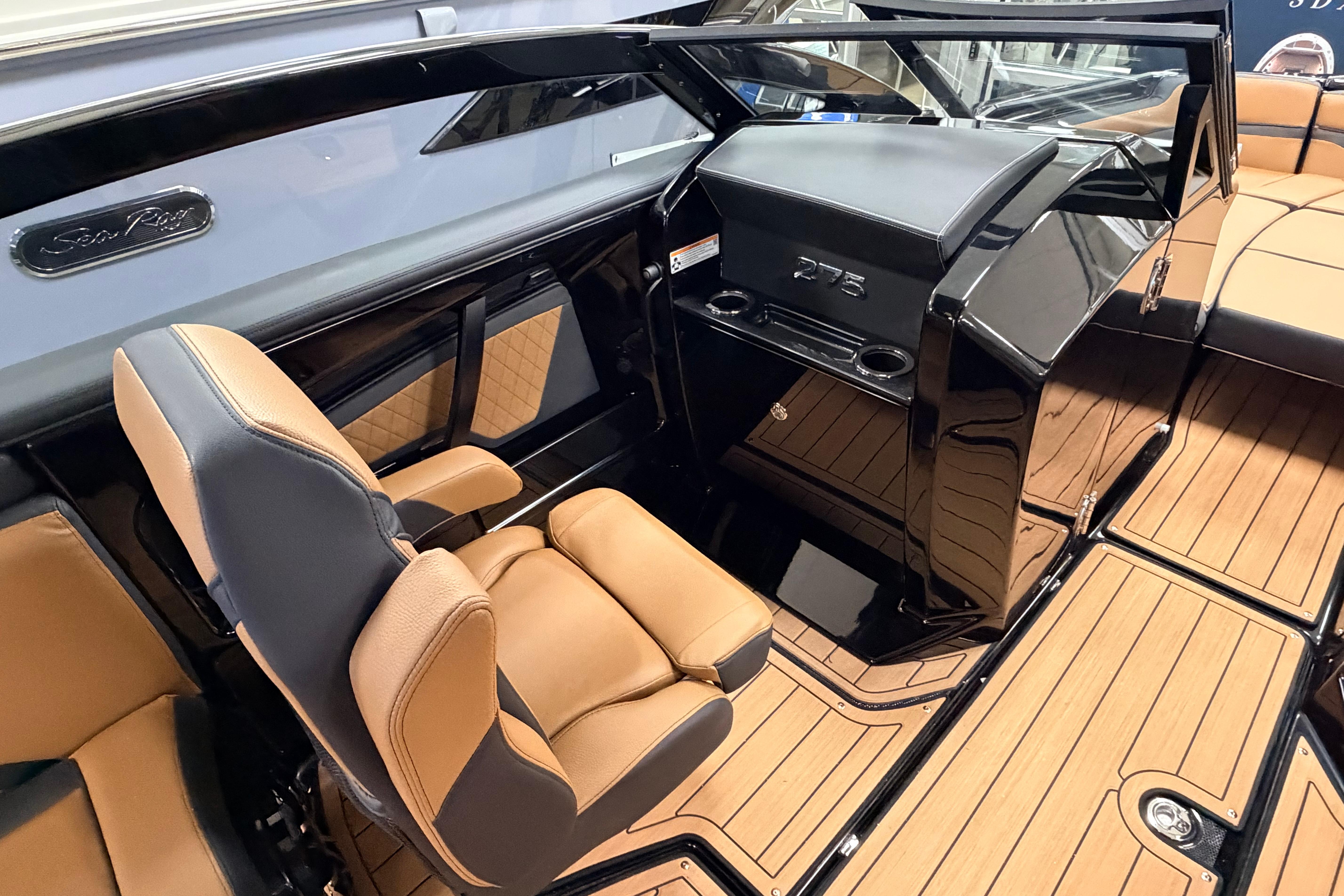 2026 Yamaha Boats 275SD interior with tan seating and sleek black dashboard.