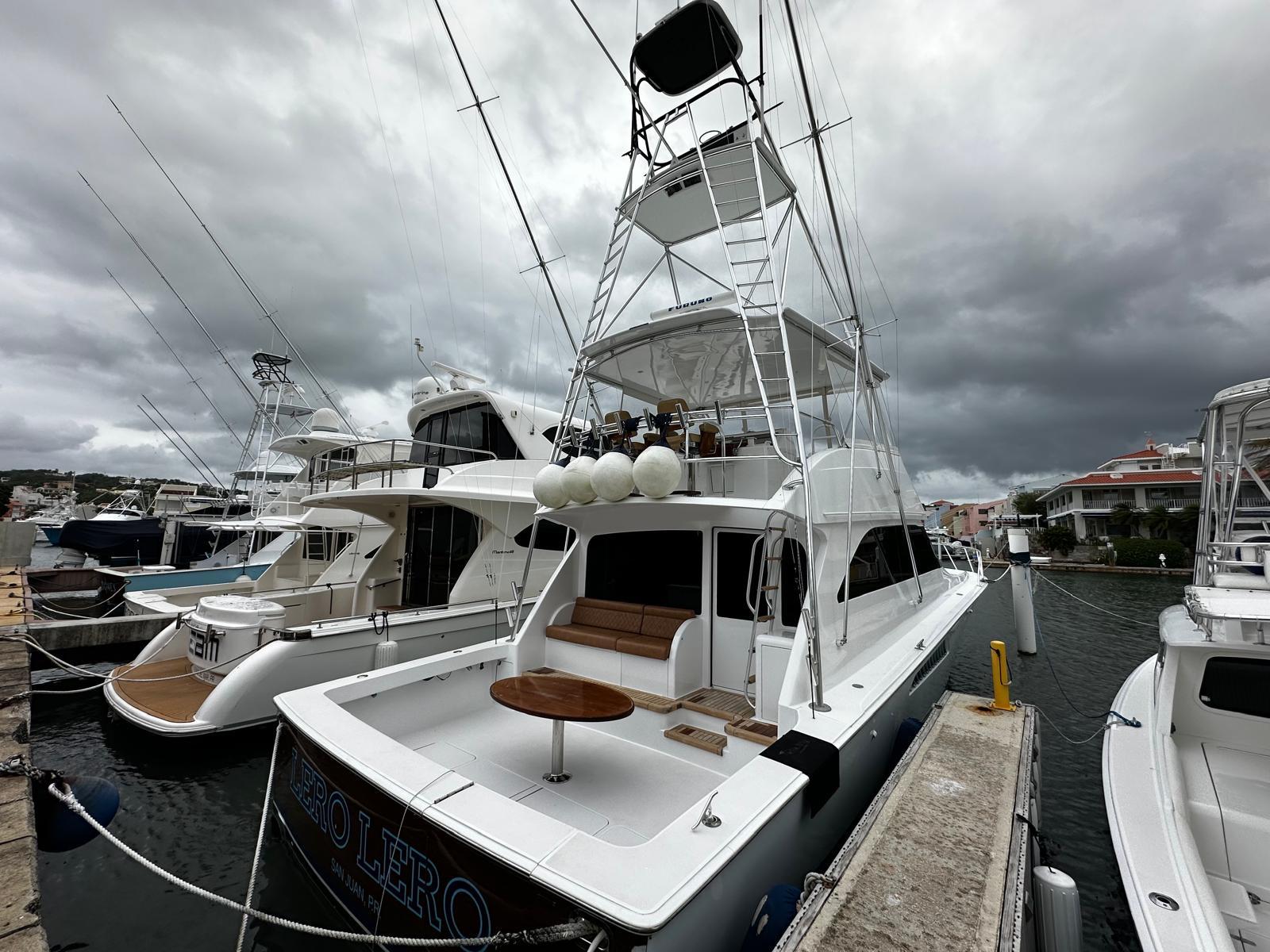 2003 Viking 52 yacht docked at marina under cloudy skies.