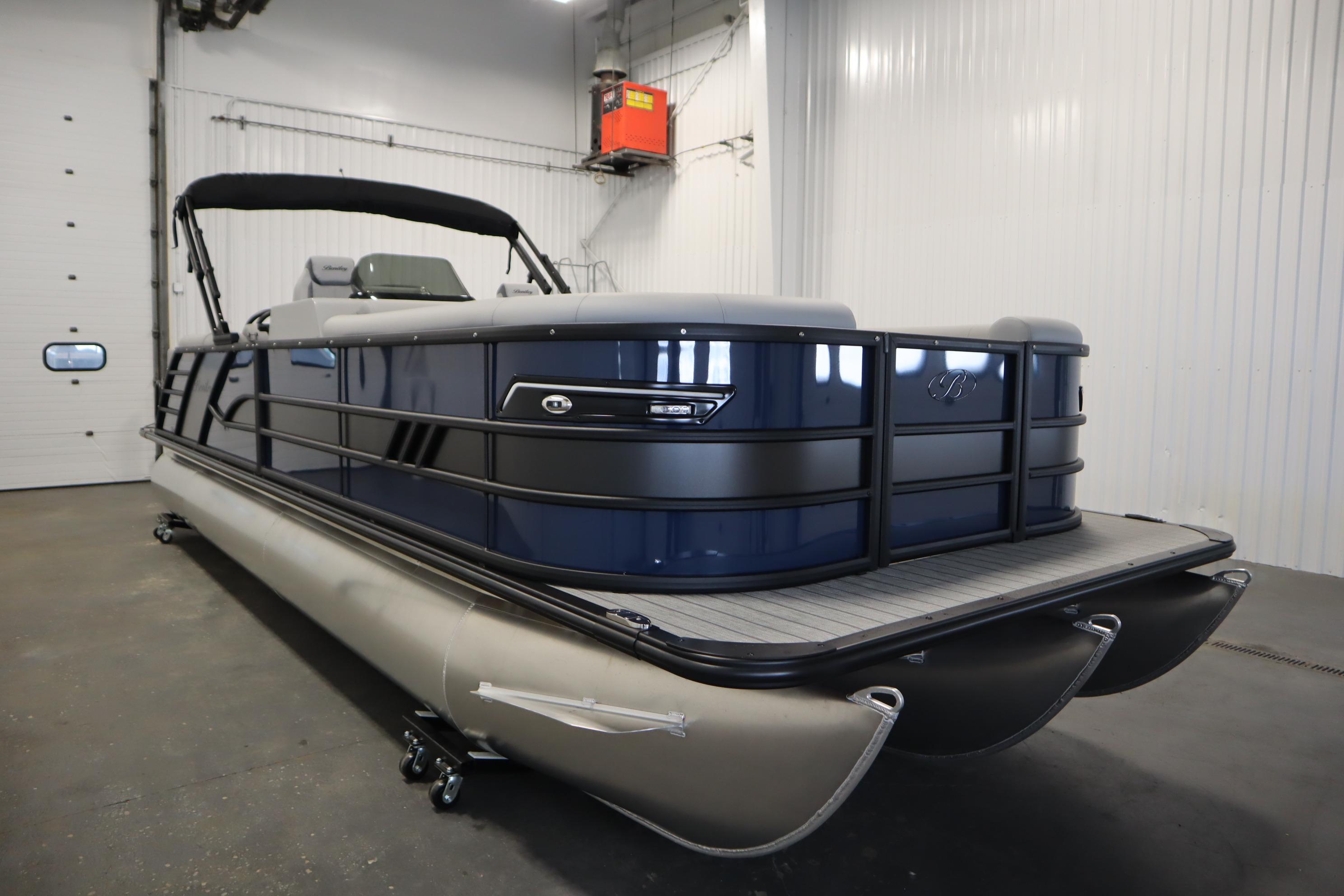 2025 Bentley Pontoons Elite 253 Admiral Tri-toon in a showroom, showcasing sleek design.