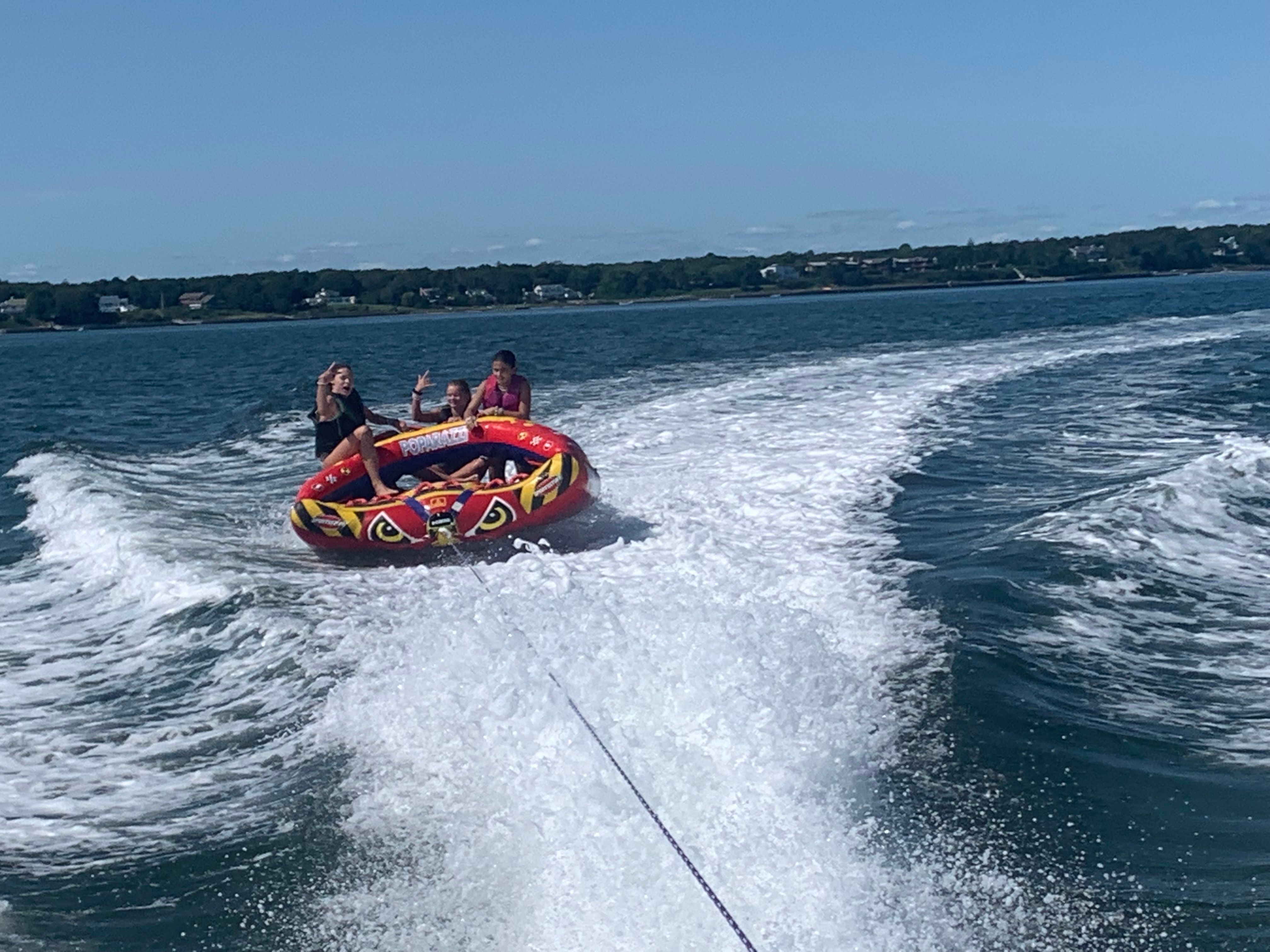 People tubing behind a 2008 Yamaha SX230 HO boat.
