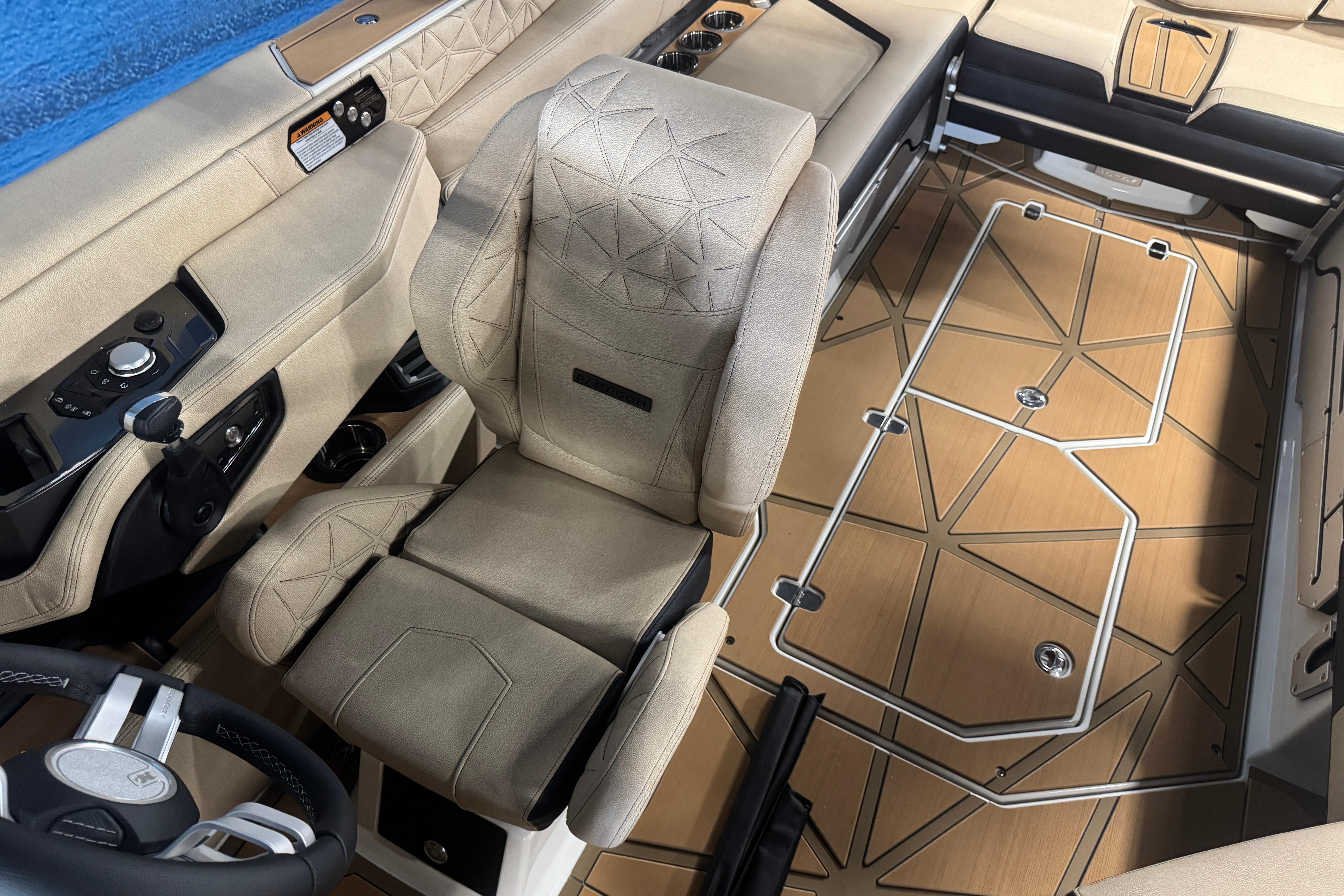 2026 Nautique Super Air Nautique G25 Paragon interior with beige seating and geometric flooring.