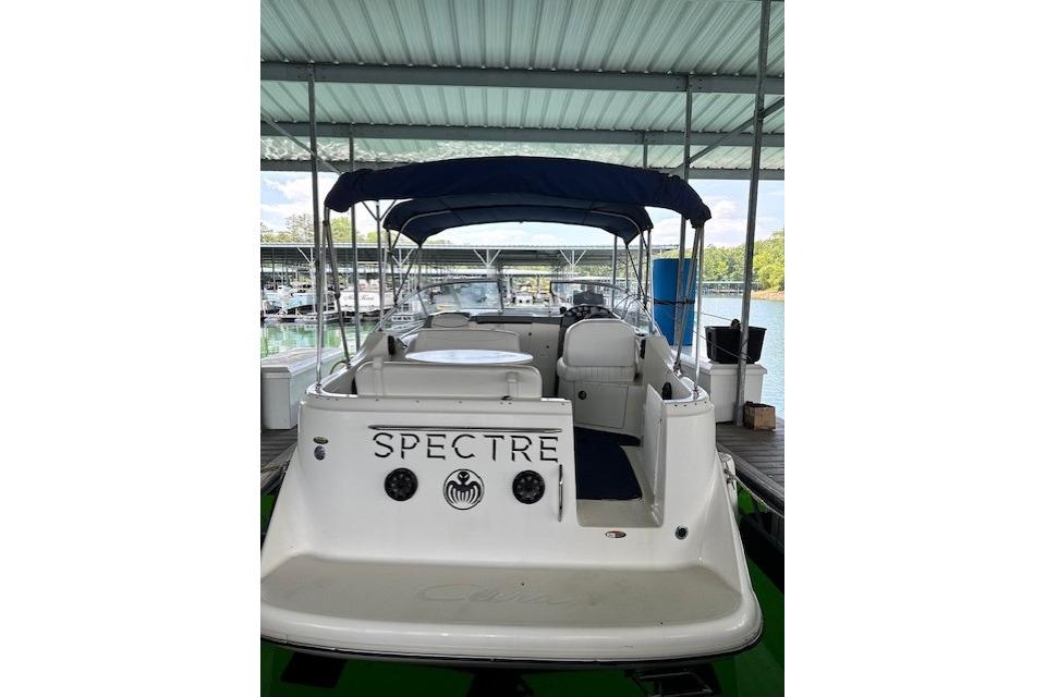 2003 Bayliner 2655 Ciera boat docked under a covered marina.
