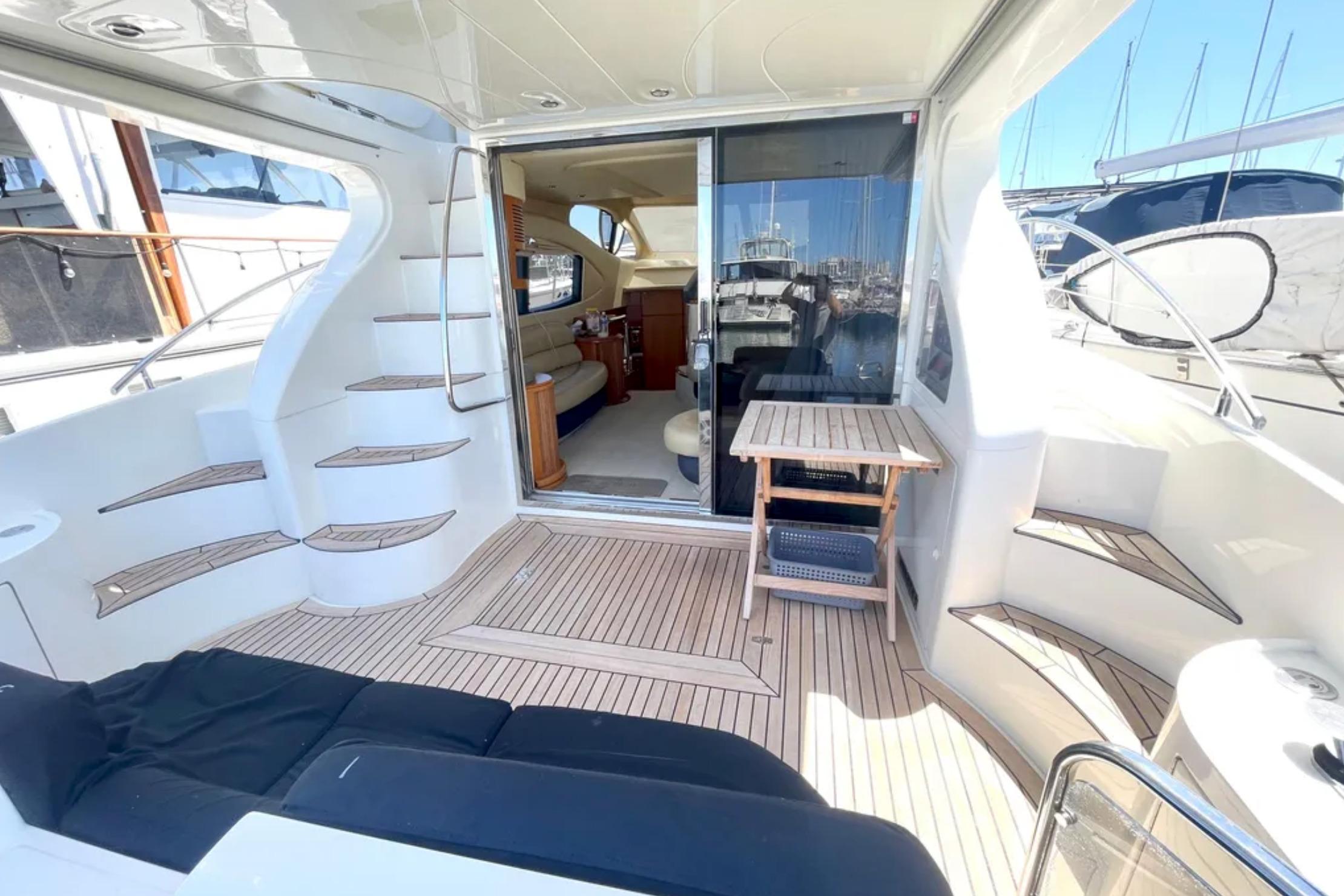 Luxurious 2004 Azimut 46 yacht interior with elegant seating and wooden flooring.
