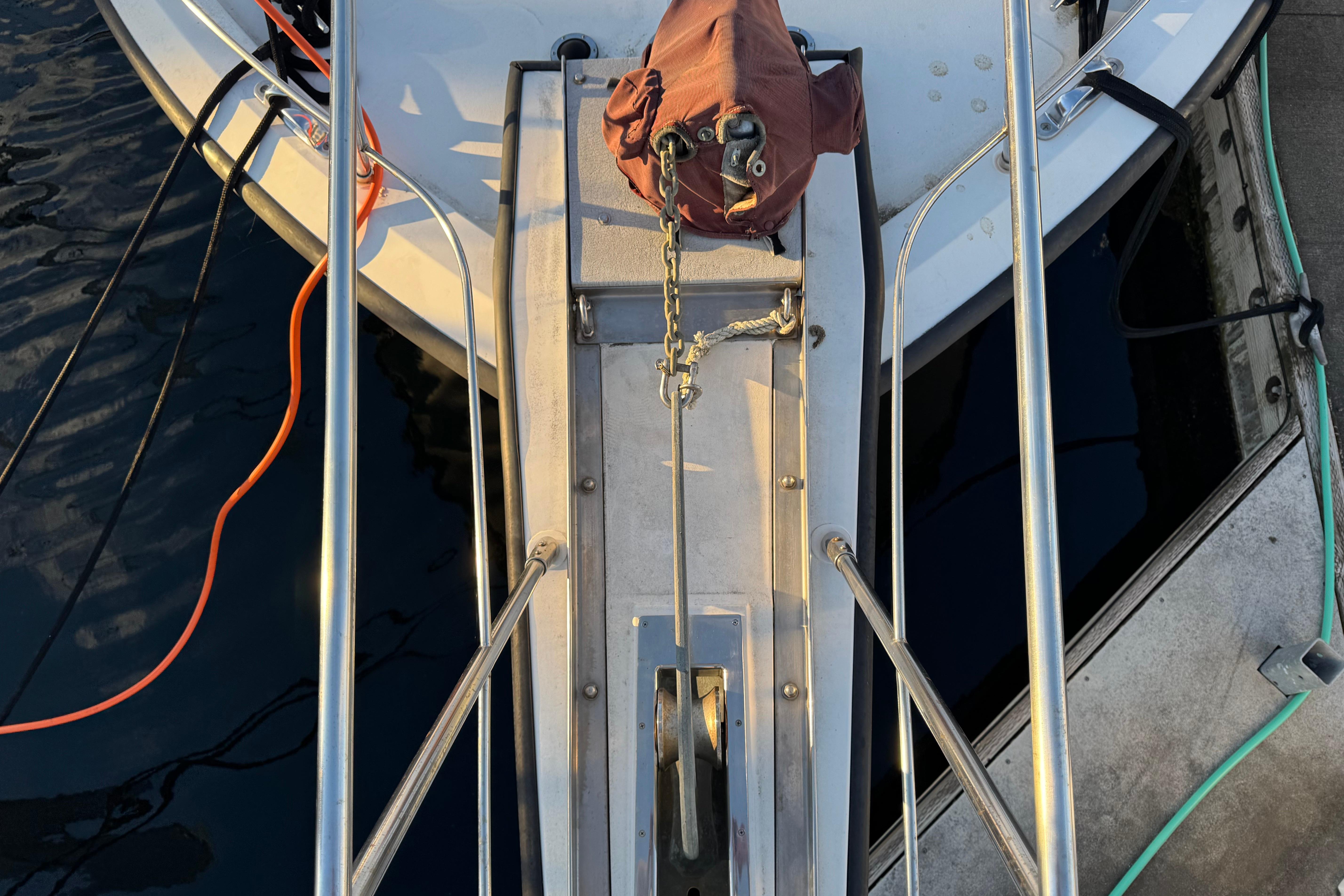 Bow of a 1987 President 37 yacht with anchor chain and ropes.
