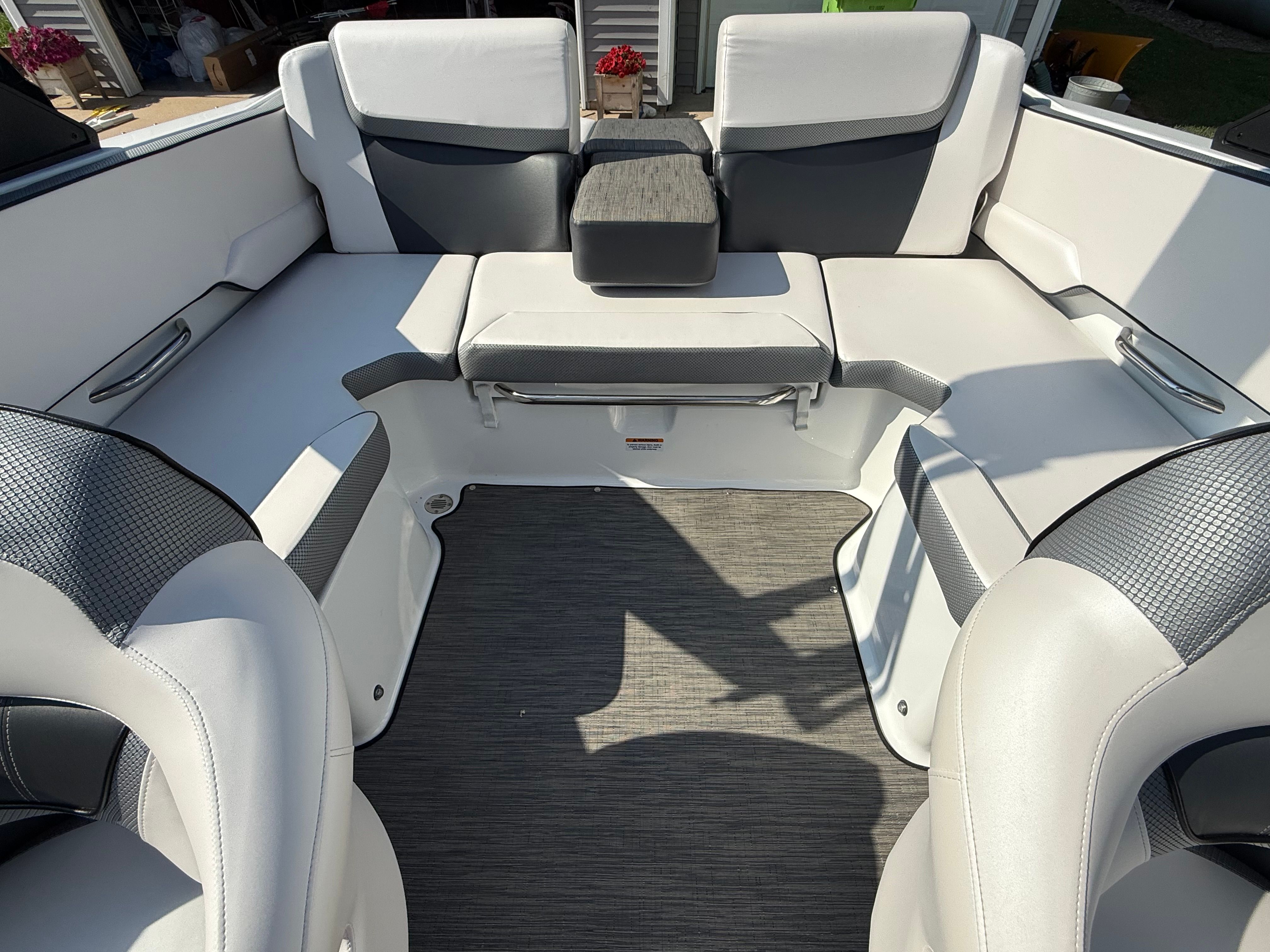 The image shows the interior of a 2023 Scarab 195 ID boat with modern, cushioned seating.