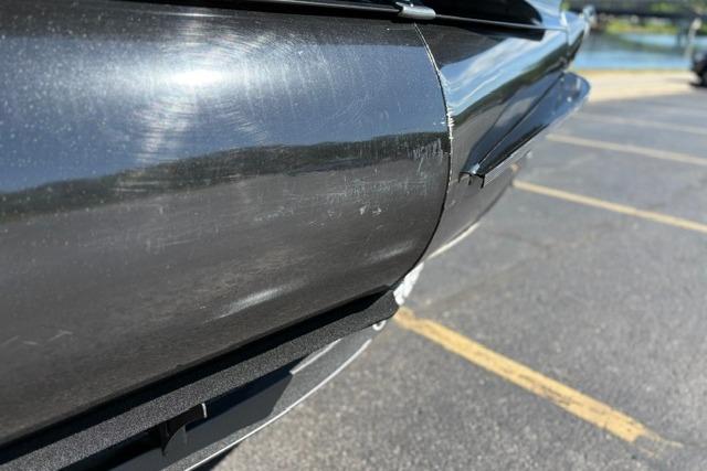Close-up of 2025 Regency 250 DL3 pontoon boat detail in a parking lot.