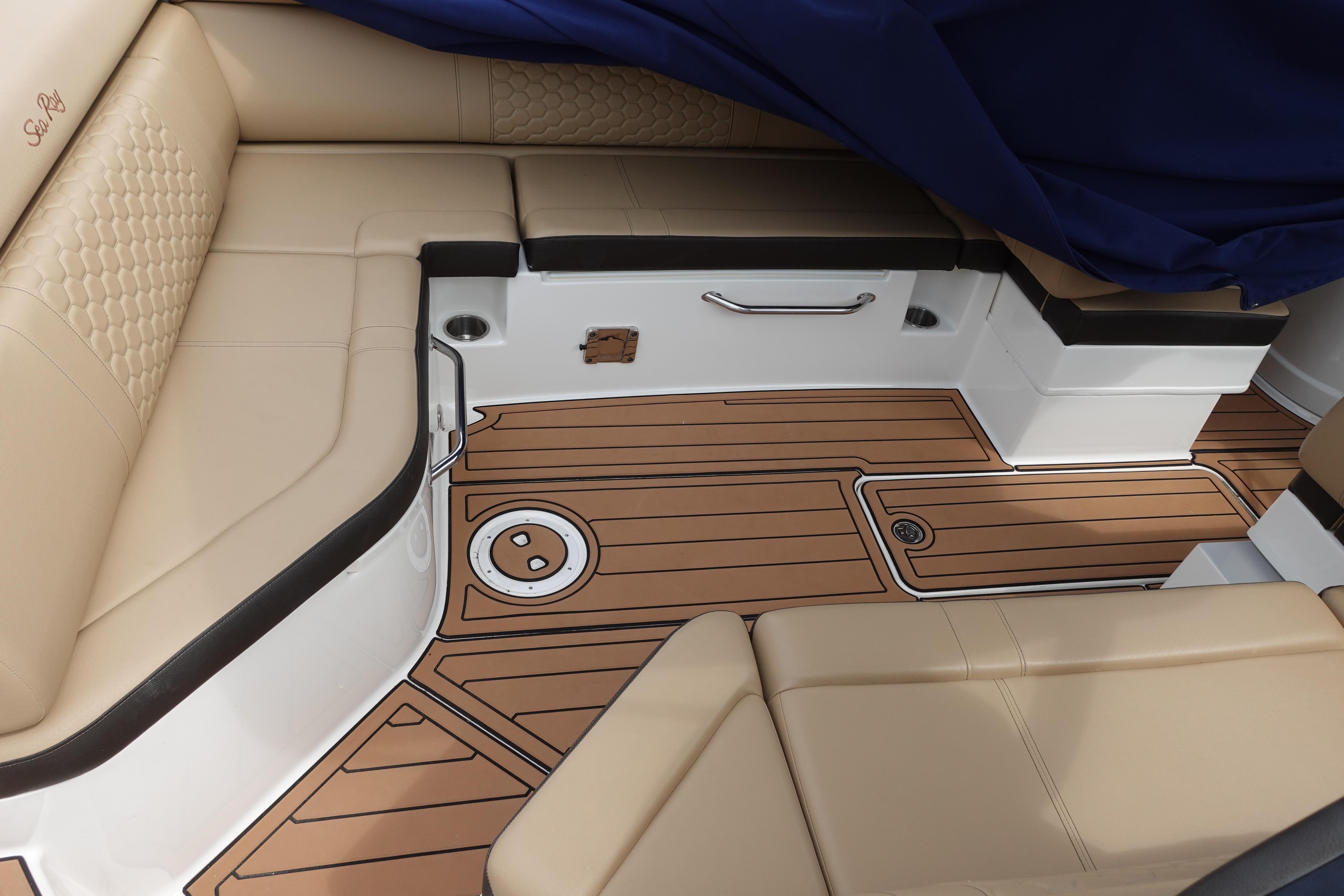 Luxurious interior of 2018 Sea Ray SDX 270 boat with tan seating and wood-style flooring.