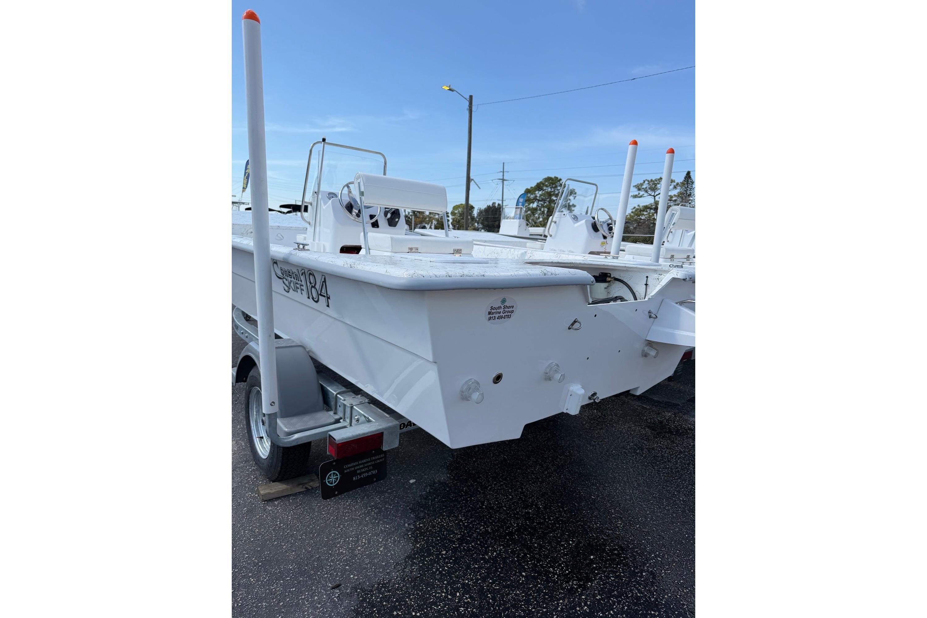 2027 Coastal Skiff 184 boat on trailer, white exterior, parked outdoors.