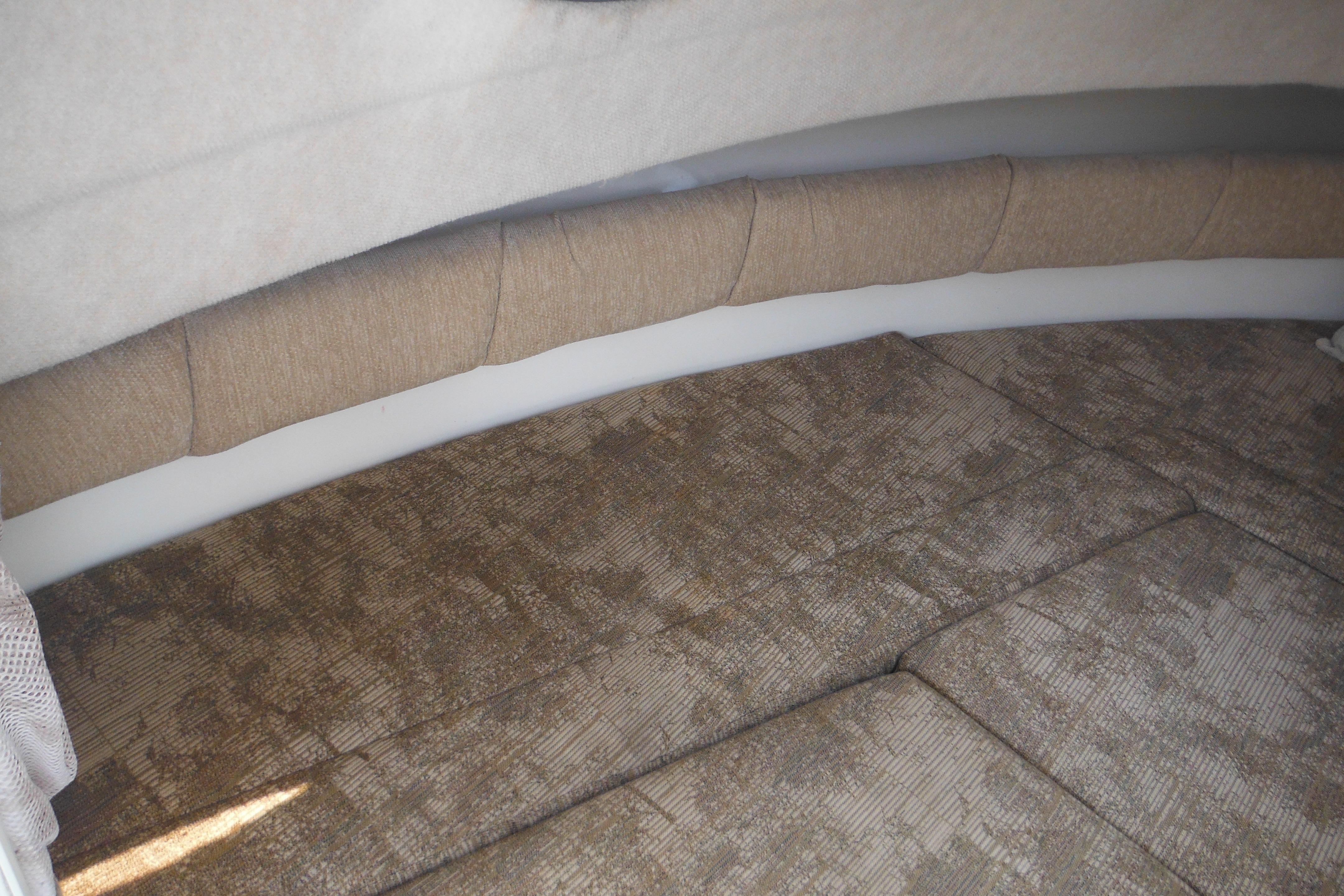Interior cabin of 2005 Seaswirl Striper 2101 Walkaround O/B with cushioned seating.