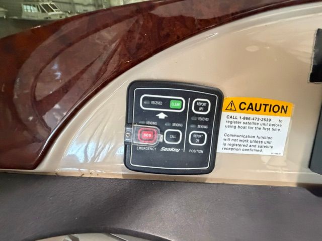 Close-up of a control panel with various buttons and caution labels.