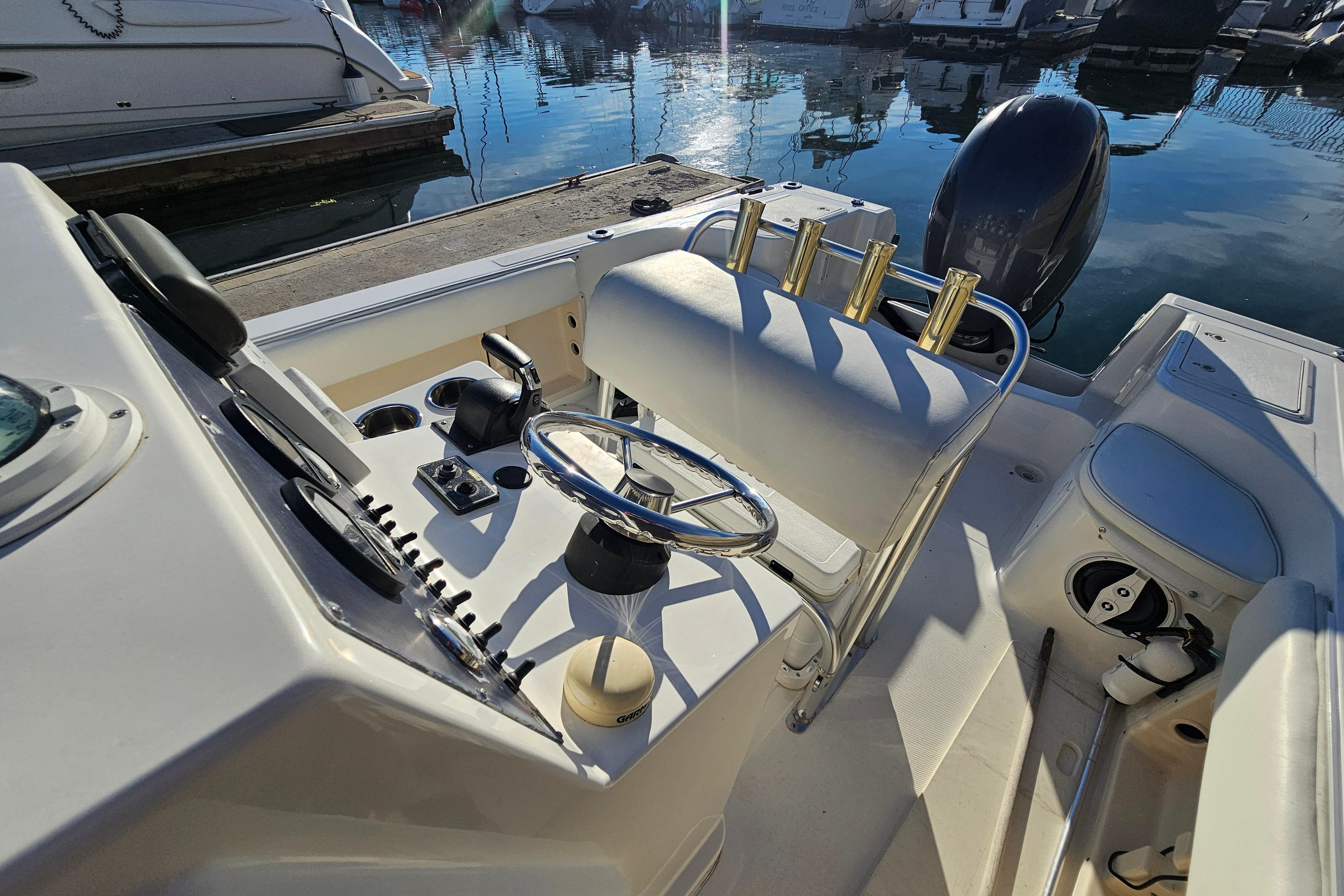 2002 Sea Fox 210 Center Console boat interior with steering wheel and controls.